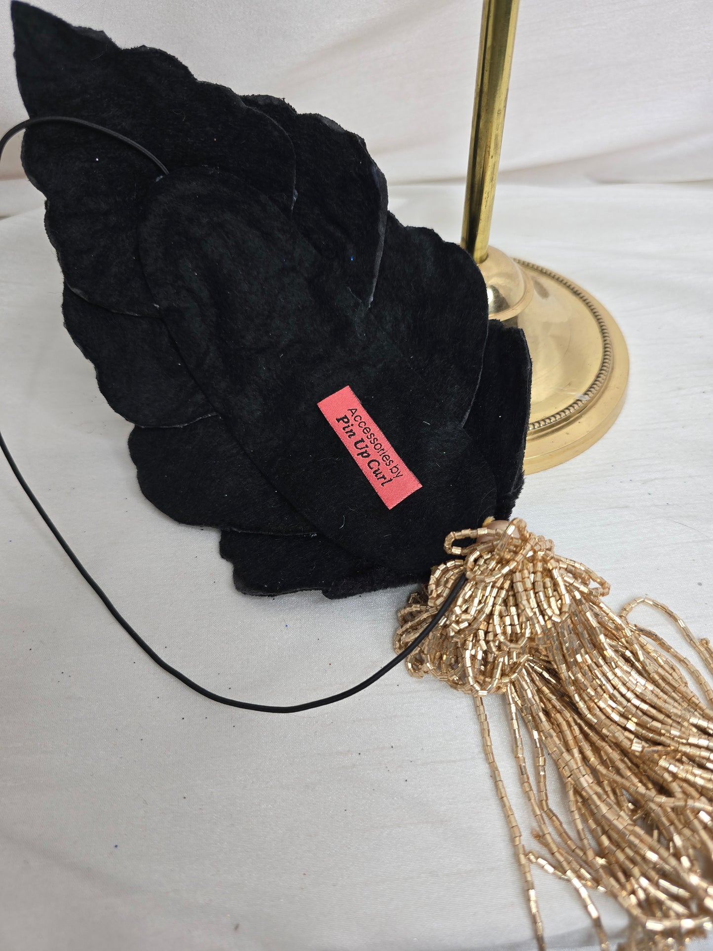 Black velvet glittered half hat/fascinator with gold beaded tassels