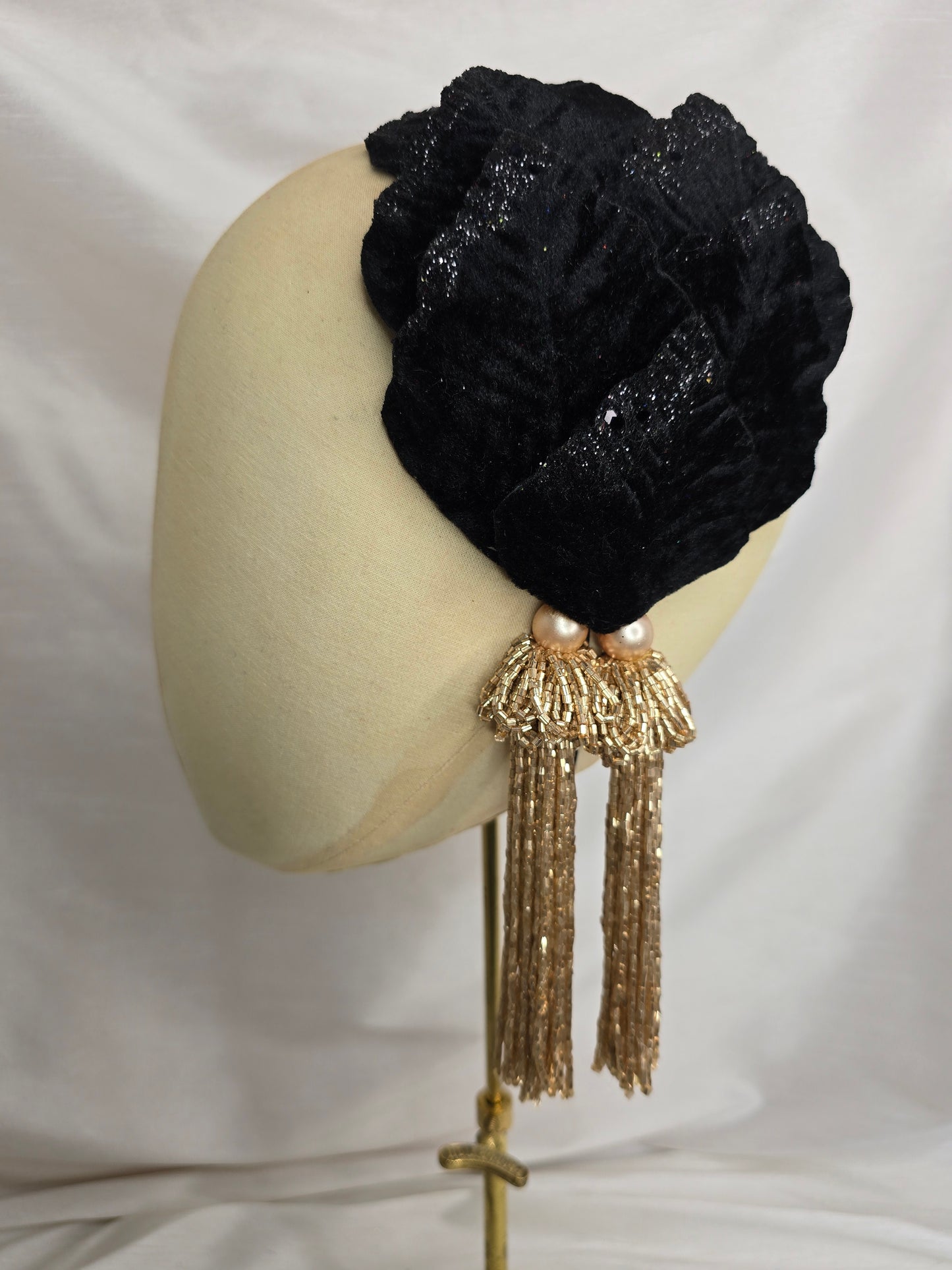 Black velvet glittered half hat/fascinator with gold beaded tassels