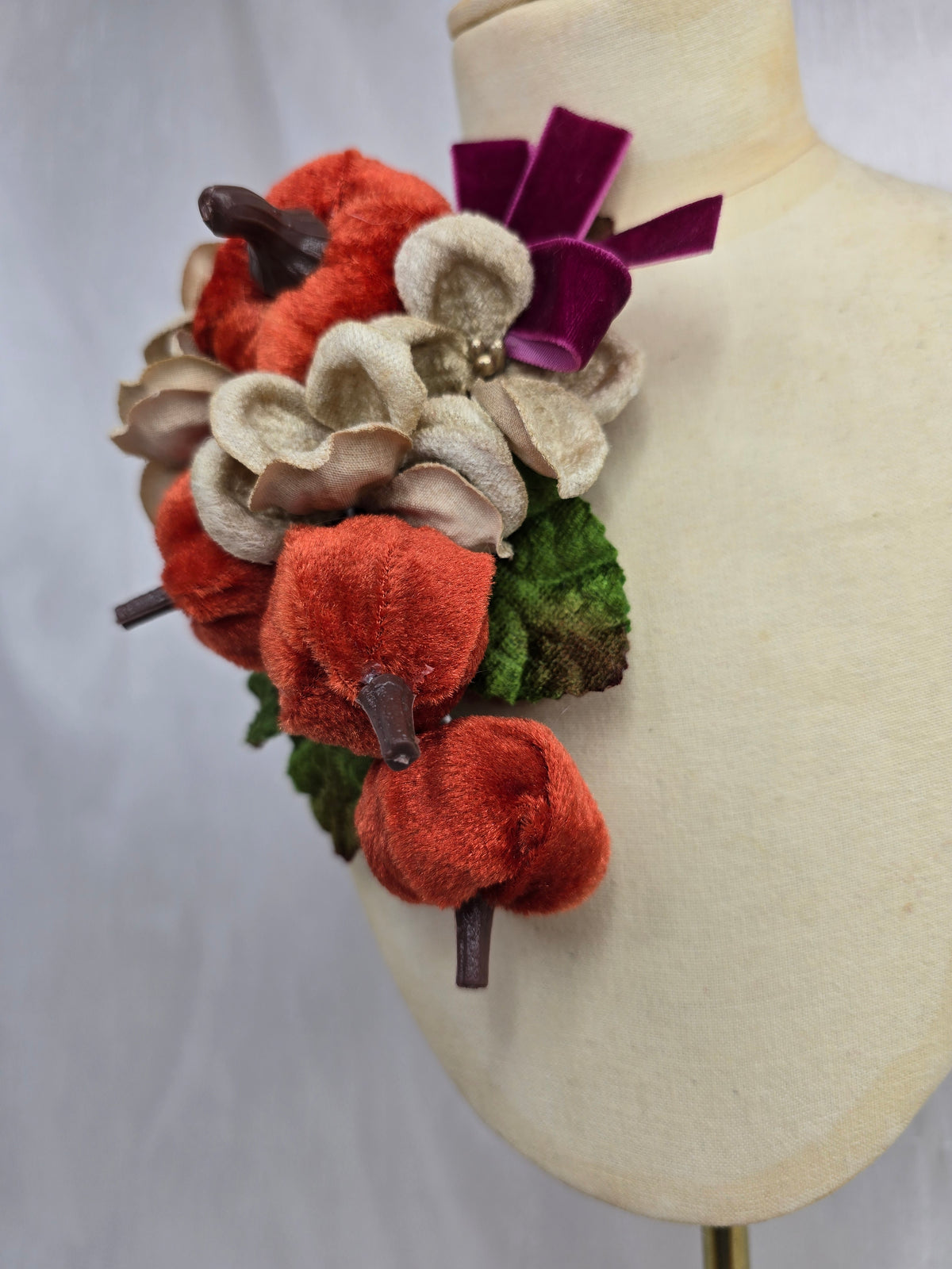 Velvet pumpkin corsage with maroon bow