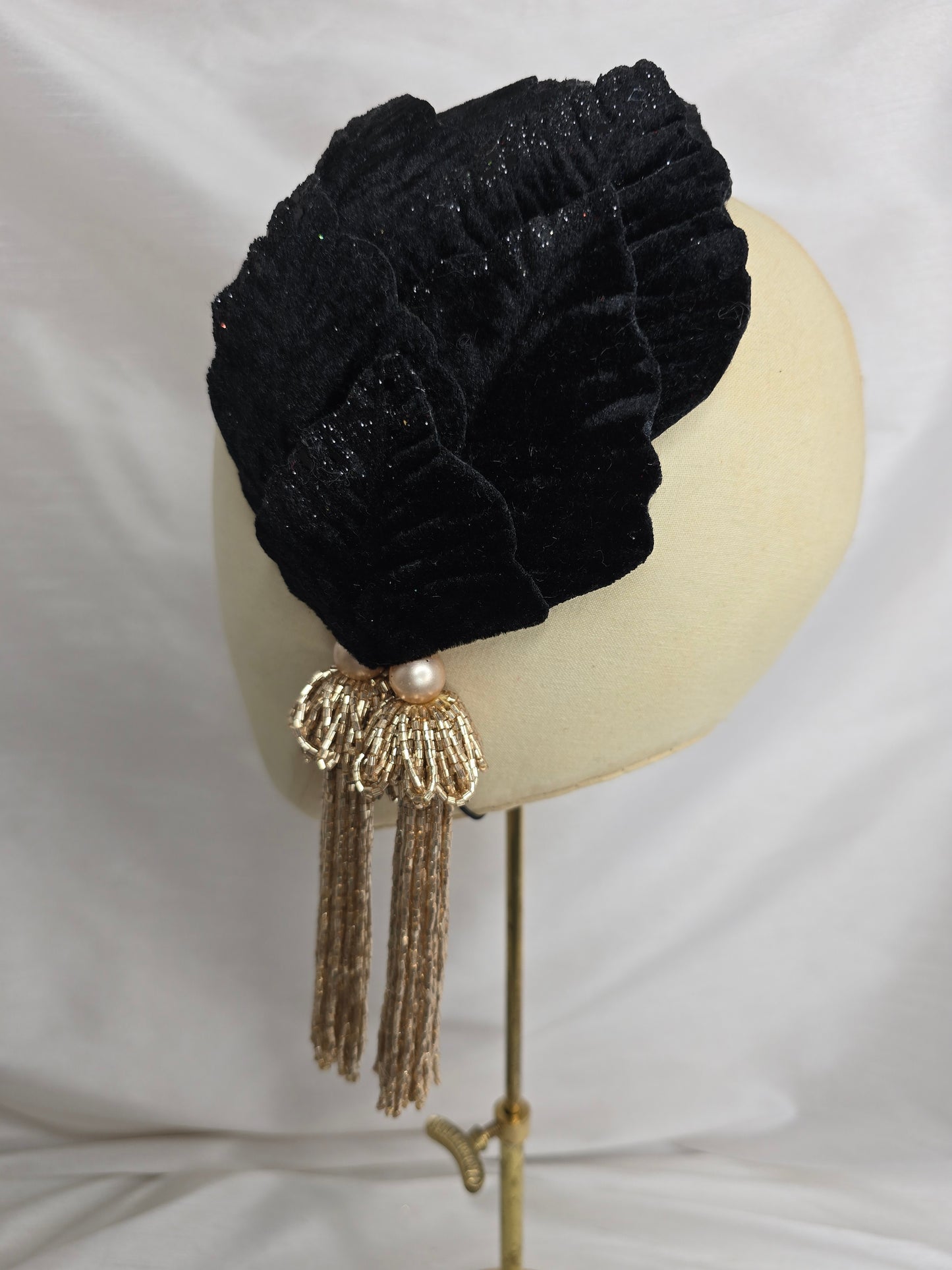 Black velvet glittered half hat/fascinator with gold beaded tassels