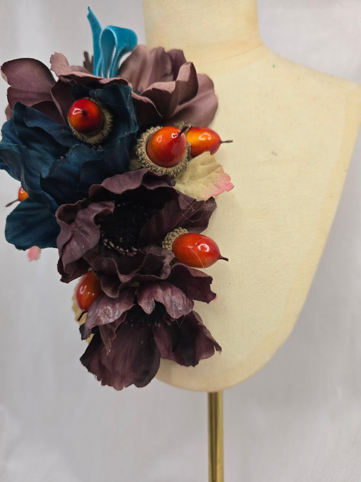 Brown and teal anemone and acorn corsage