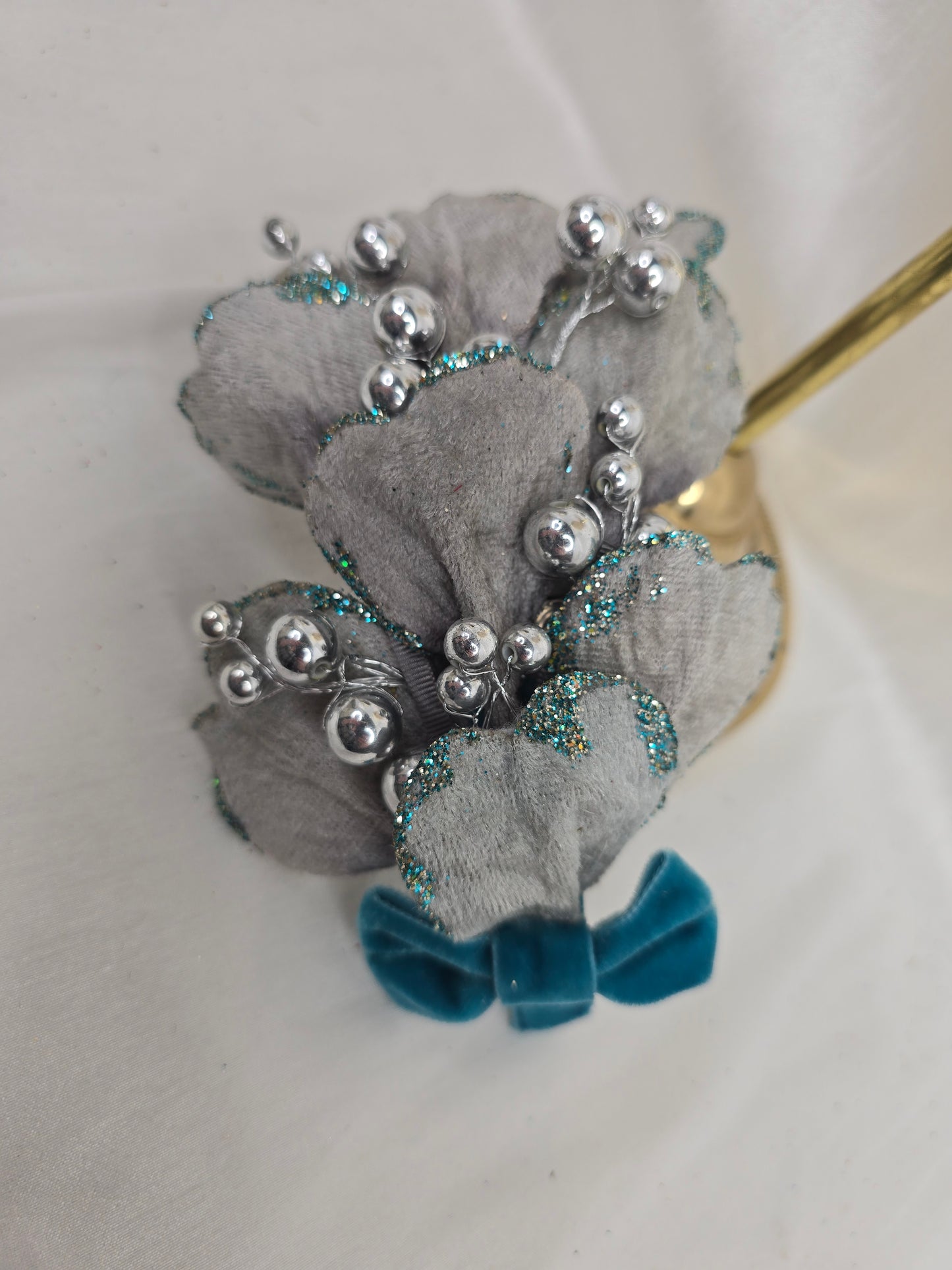 Silver velvet and aqua petal fascinator with bow and berries