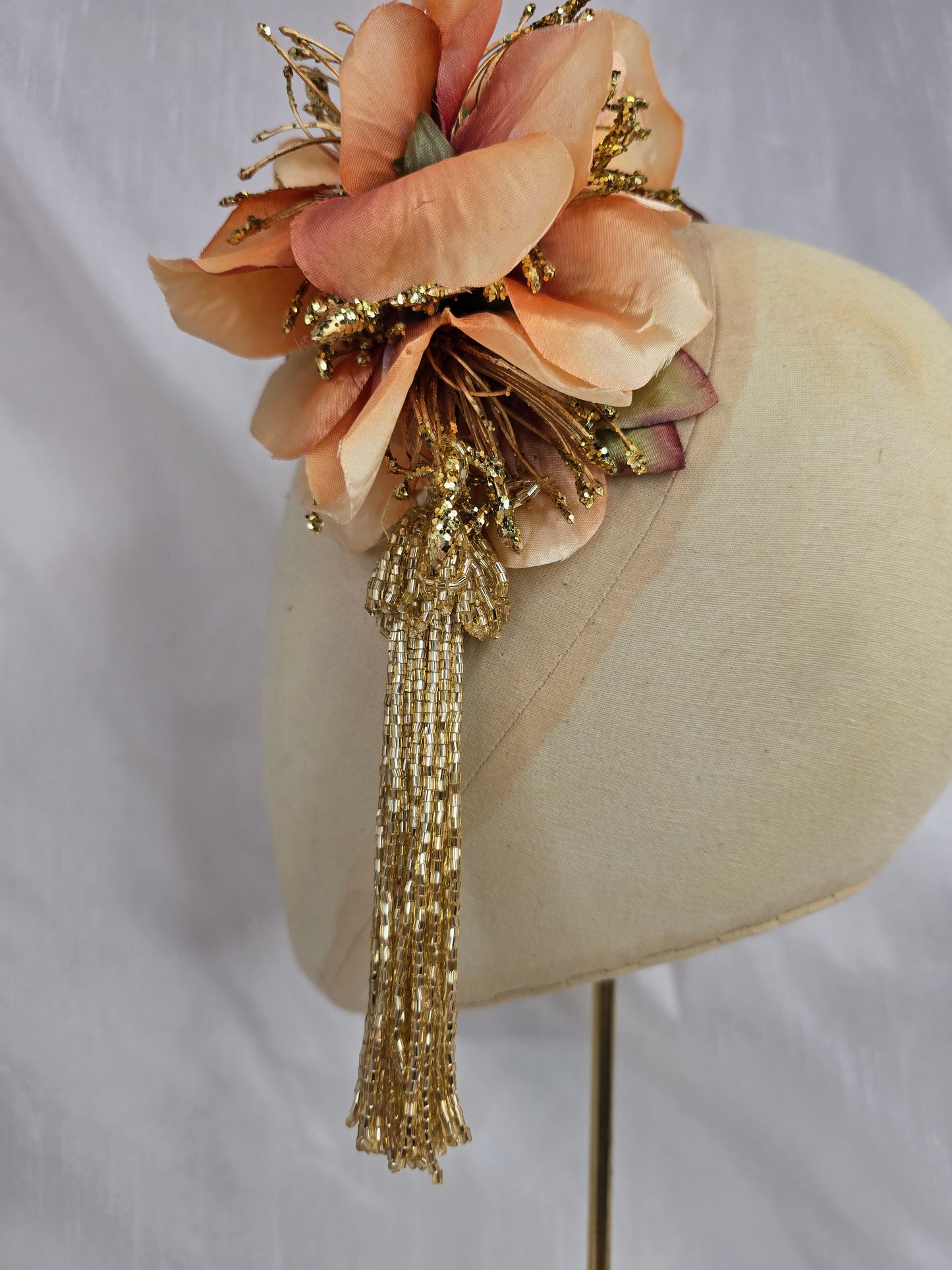Medium pale orange and gold hair flower/corsage with beaded tassel