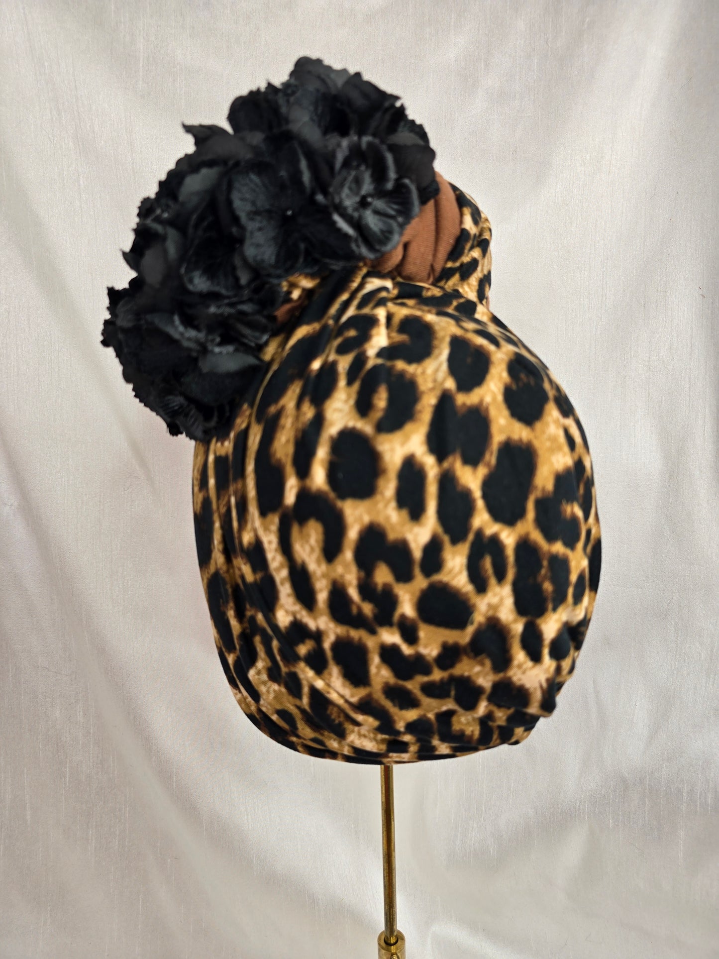 Leopard and tan stretch jersey turban with flower trim and corsage