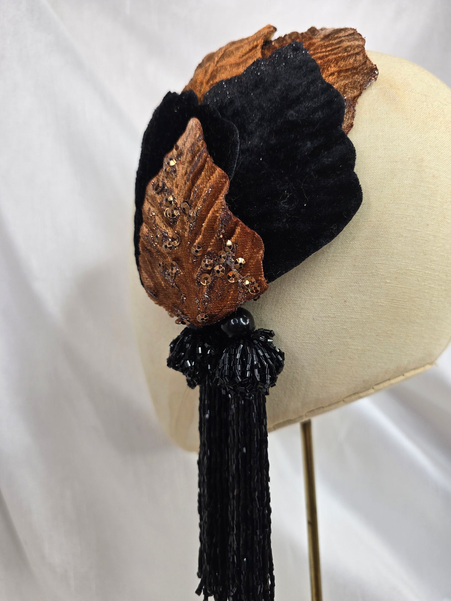 Black and copper half hat/fascinator with beaded tassels