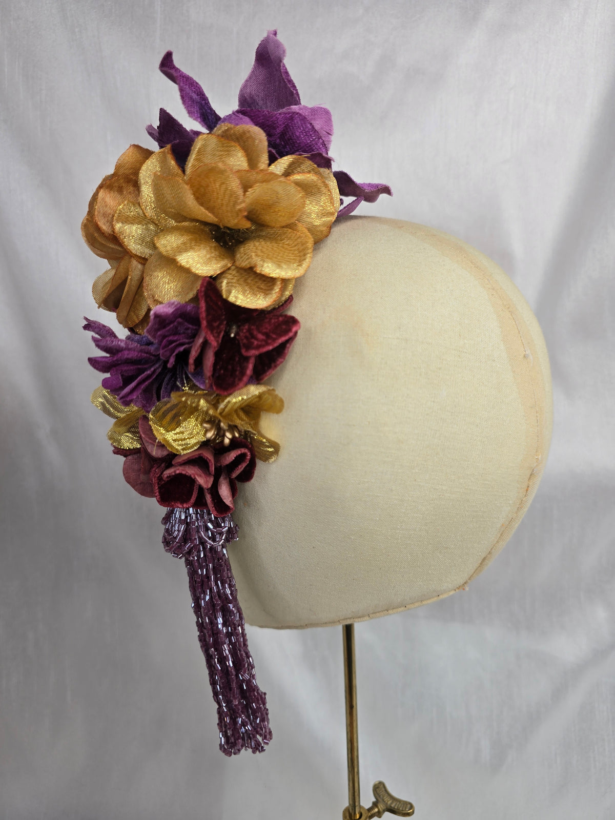 Medium purple and gold flower headpiece/corsage with beaded tassel