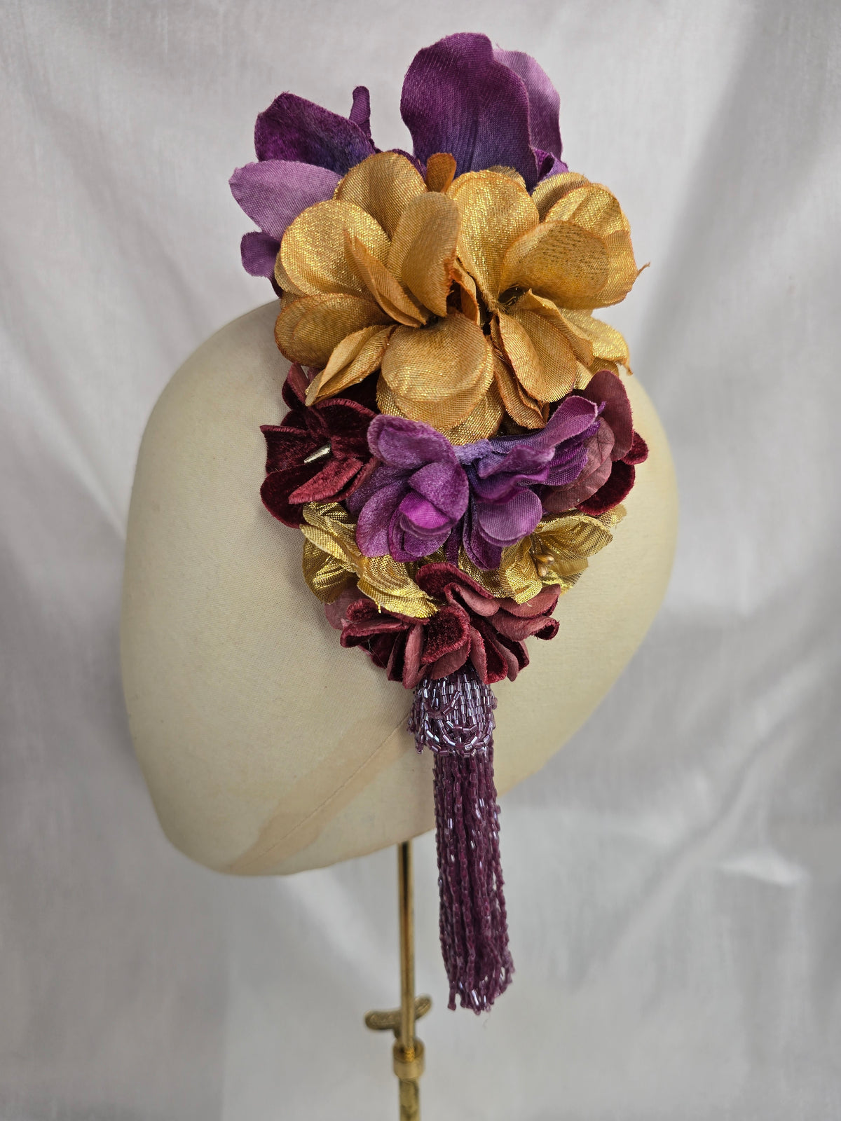 Medium purple and gold flower headpiece/corsage with beaded tassel