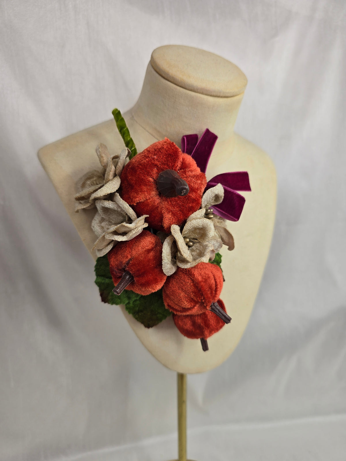 Velvet pumpkin corsage with maroon bow
