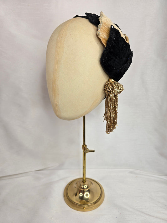 Black and champagne glittered half hat/fascinator with gold beaded tassels