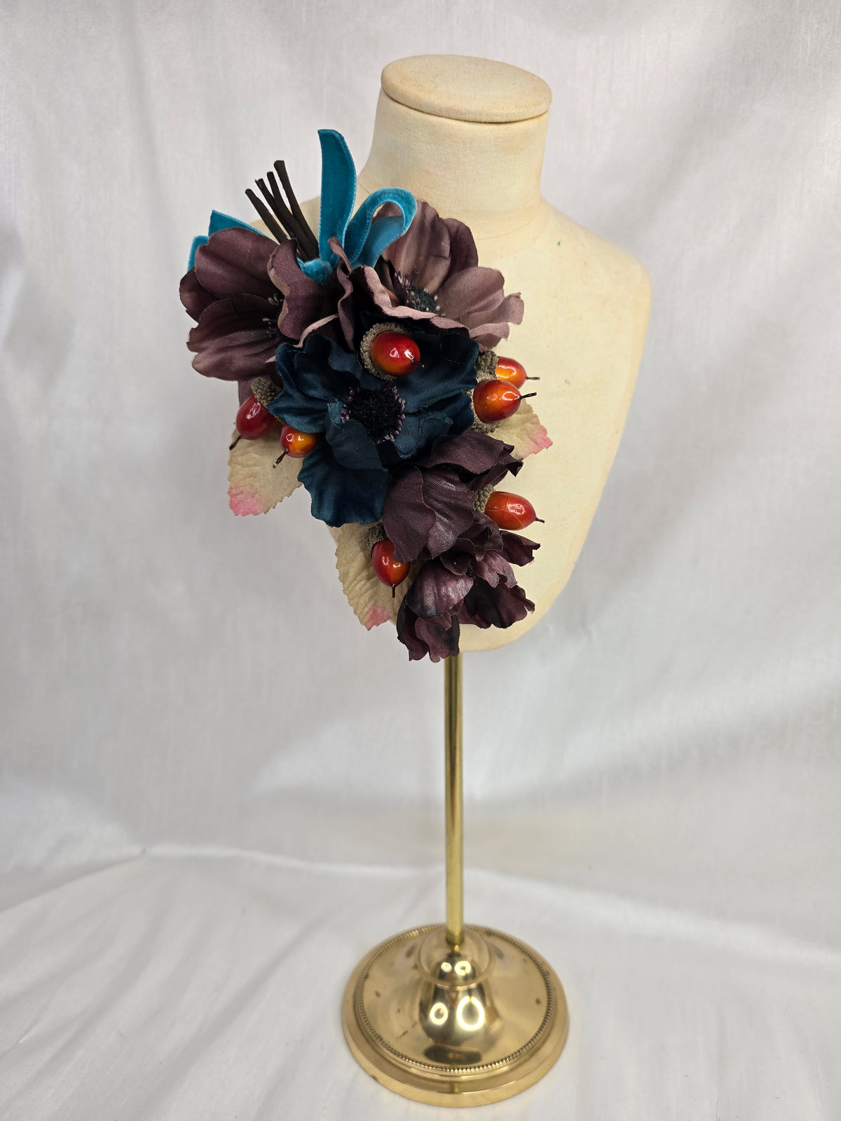 Brown and teal anemone and acorn corsage