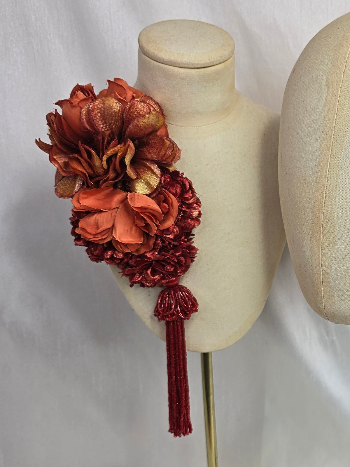 Medium autumn orange flower headpiece/corsage with beaded tassel