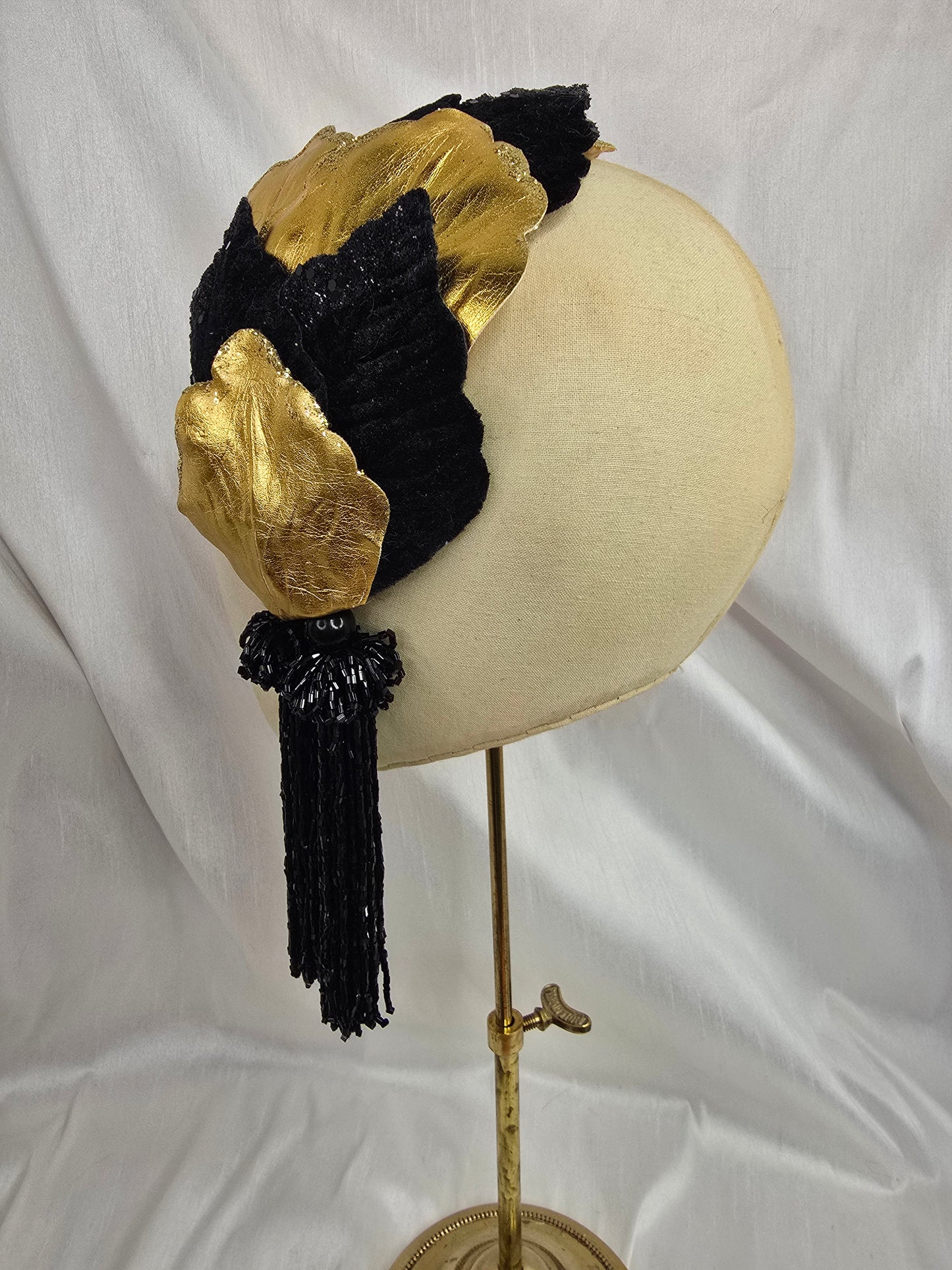 Black and gold glittered half hat/fascinator with beaded tassels