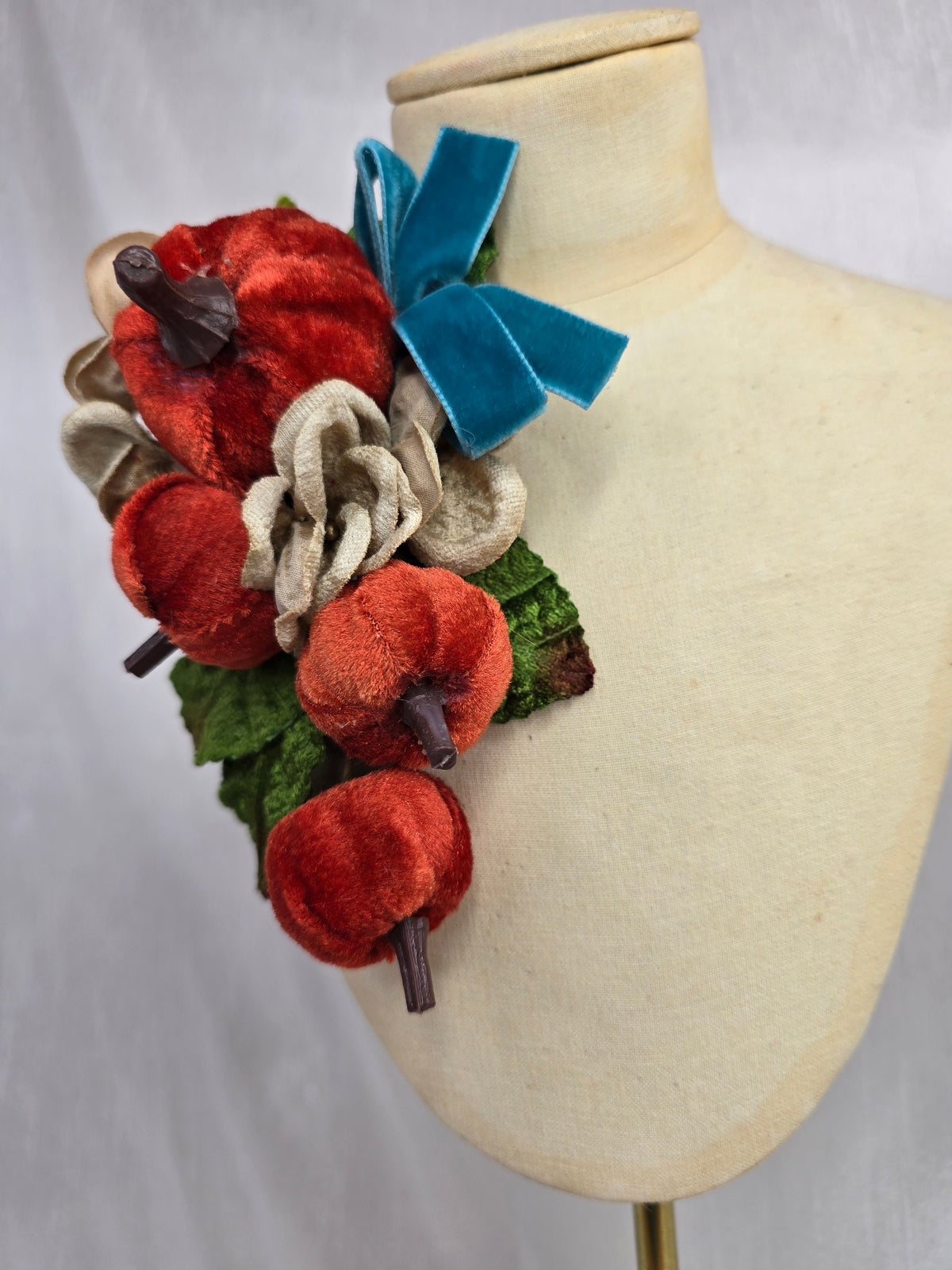 Velvet pumpkin corsage with teal bow