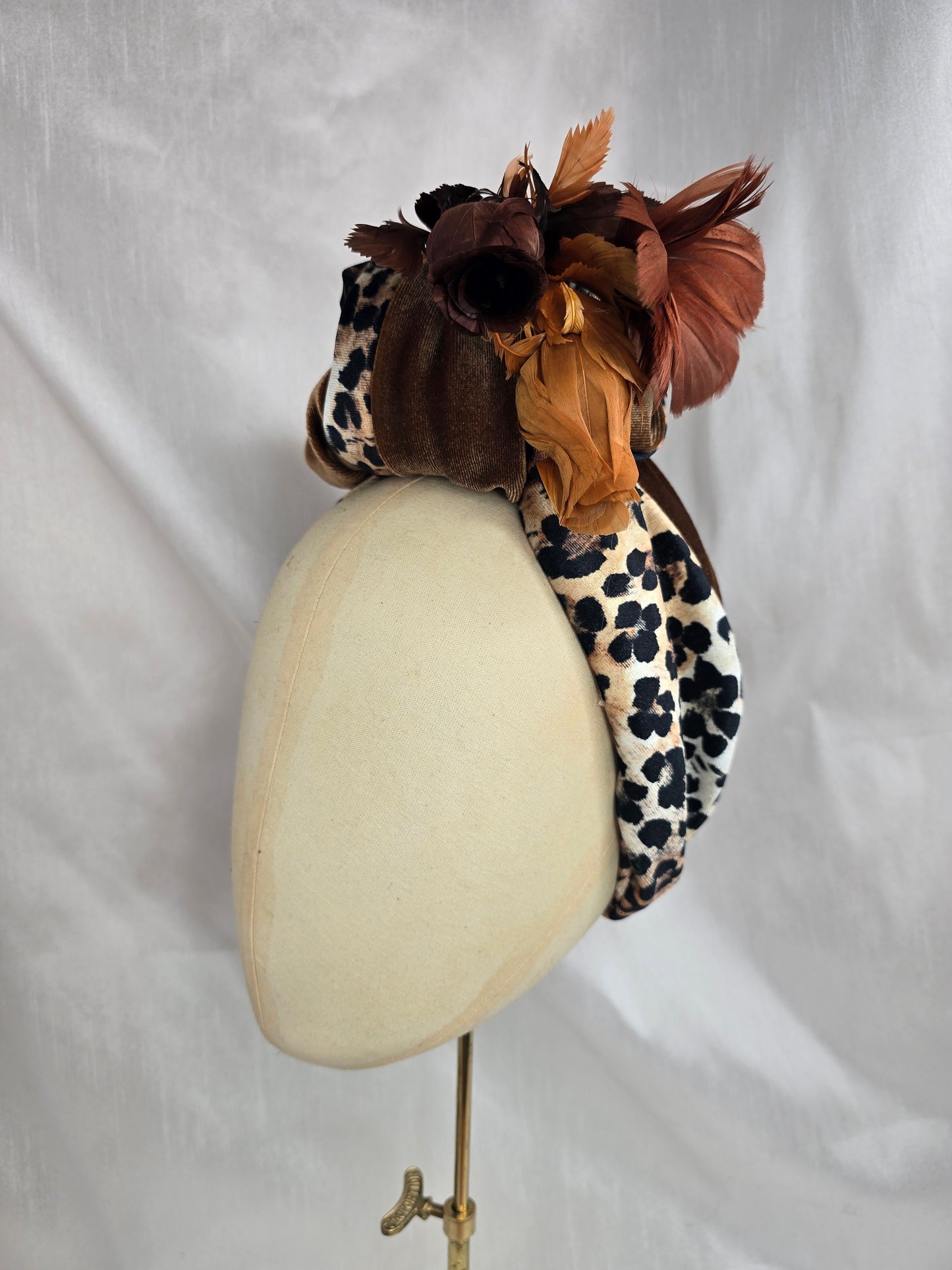 Tan and leopard stretch velvet turban with vintage feather trim and corsage