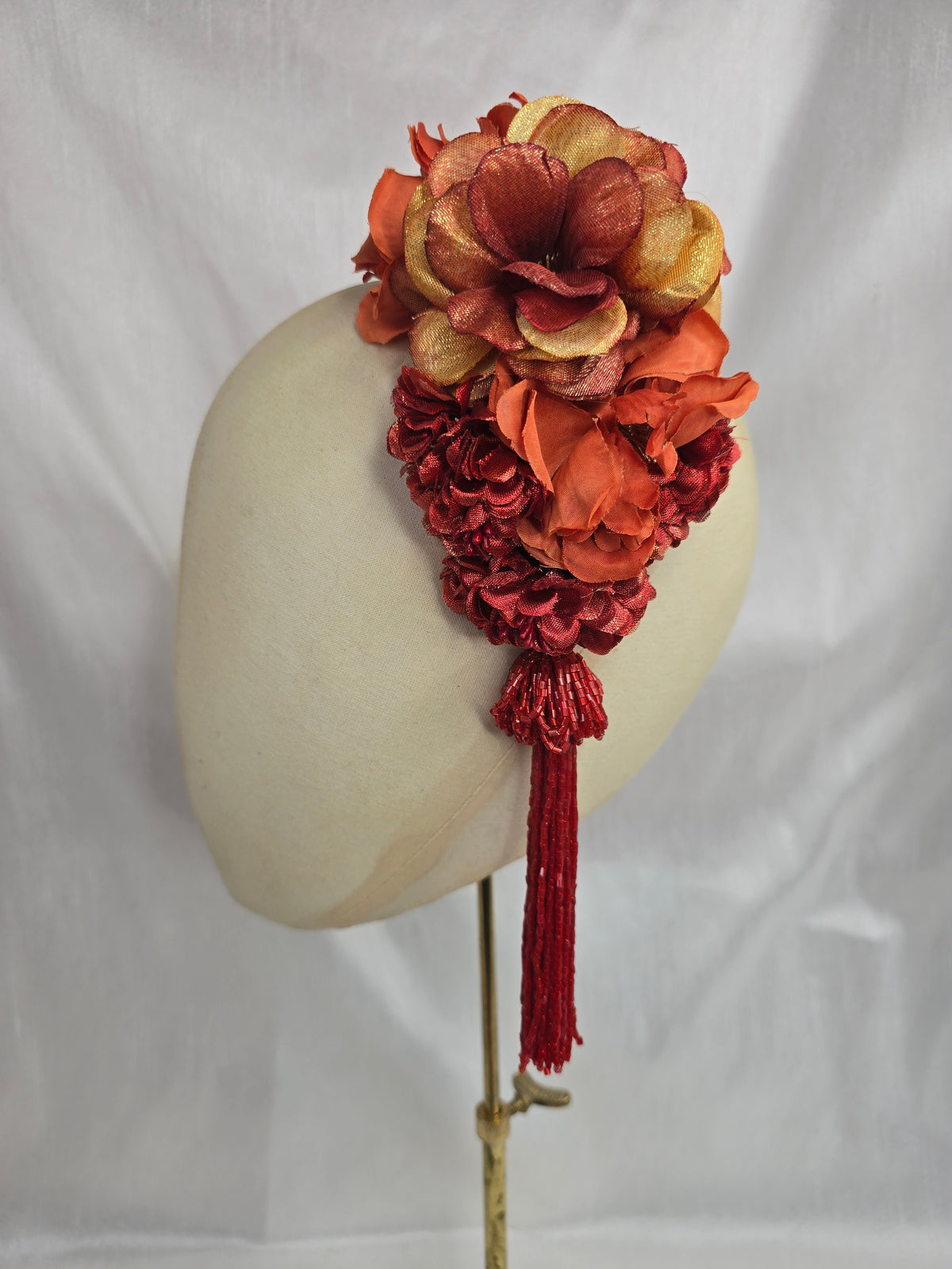 Medium autumn orange flower headpiece/corsage with beaded tassel