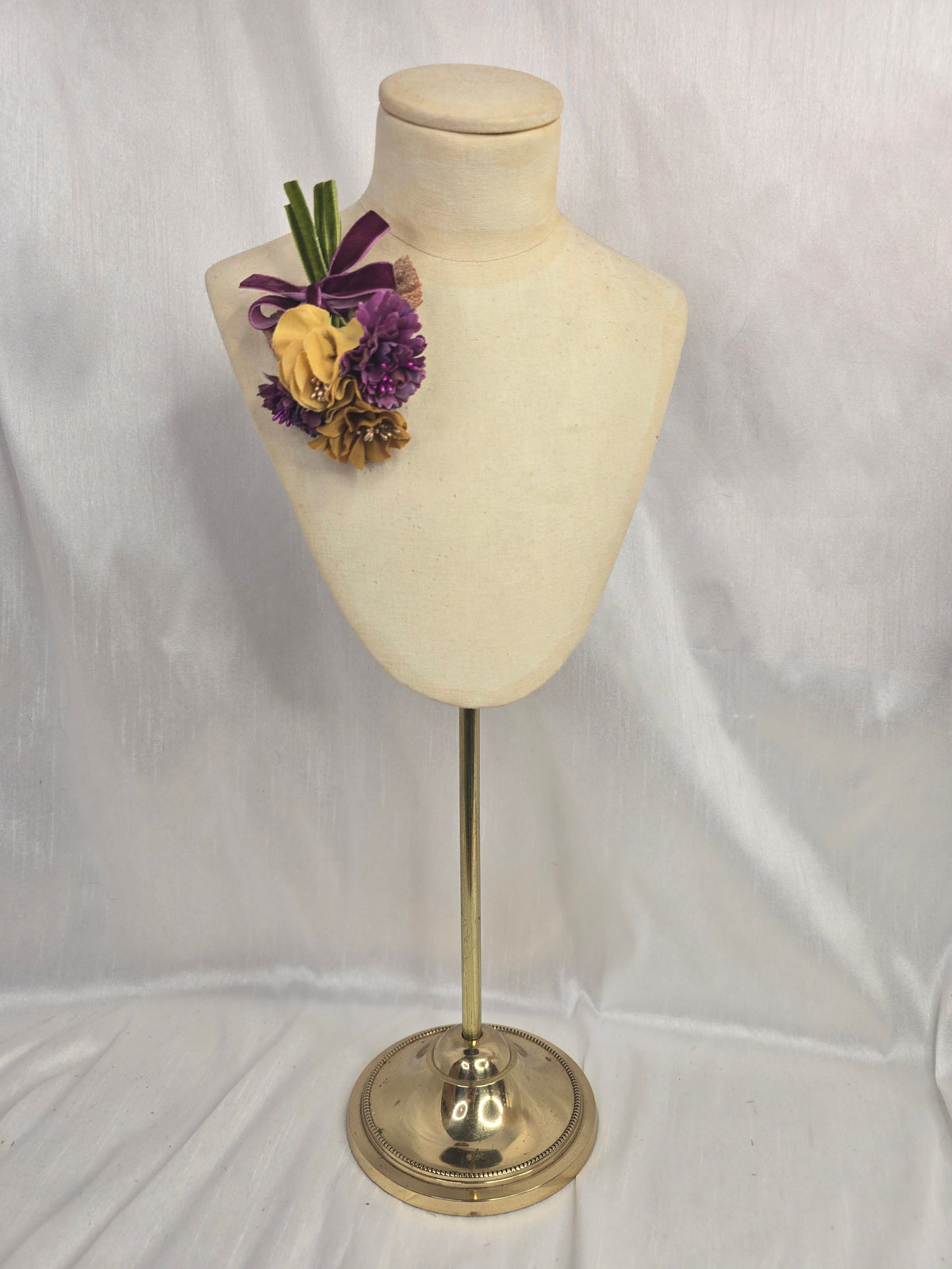 Mustard and purple blossom corsage