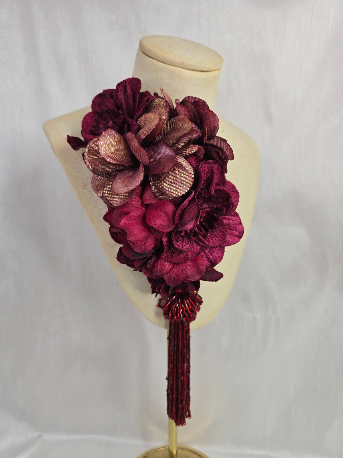 Medium burgundy and maroon flower headpiece/corsage with beaded tassel