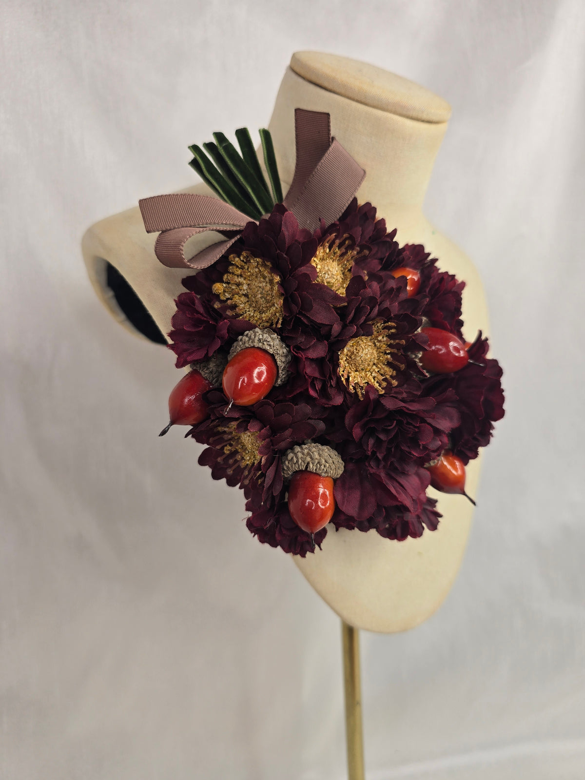 Maroon chrysanthemum and acorn corsage