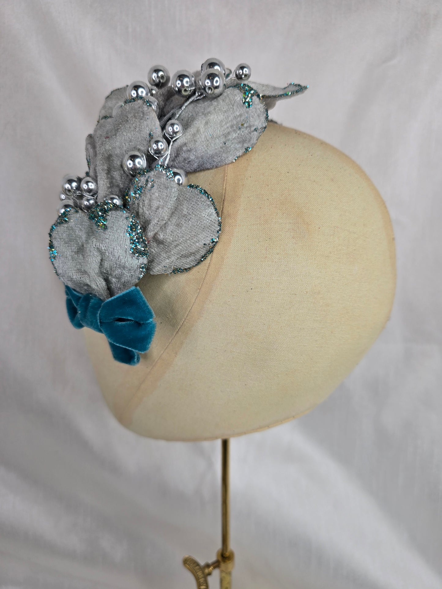 Silver velvet and aqua petal fascinator with bow and berries
