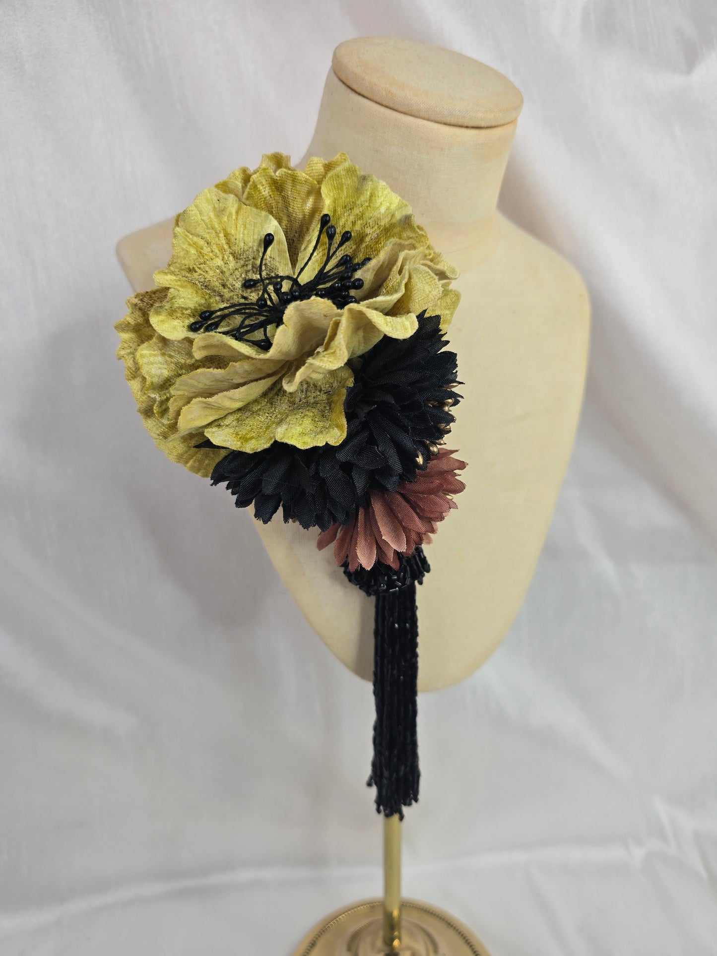 Medium chartruese yellow, black and gold flower headpiece with black beaded tassel