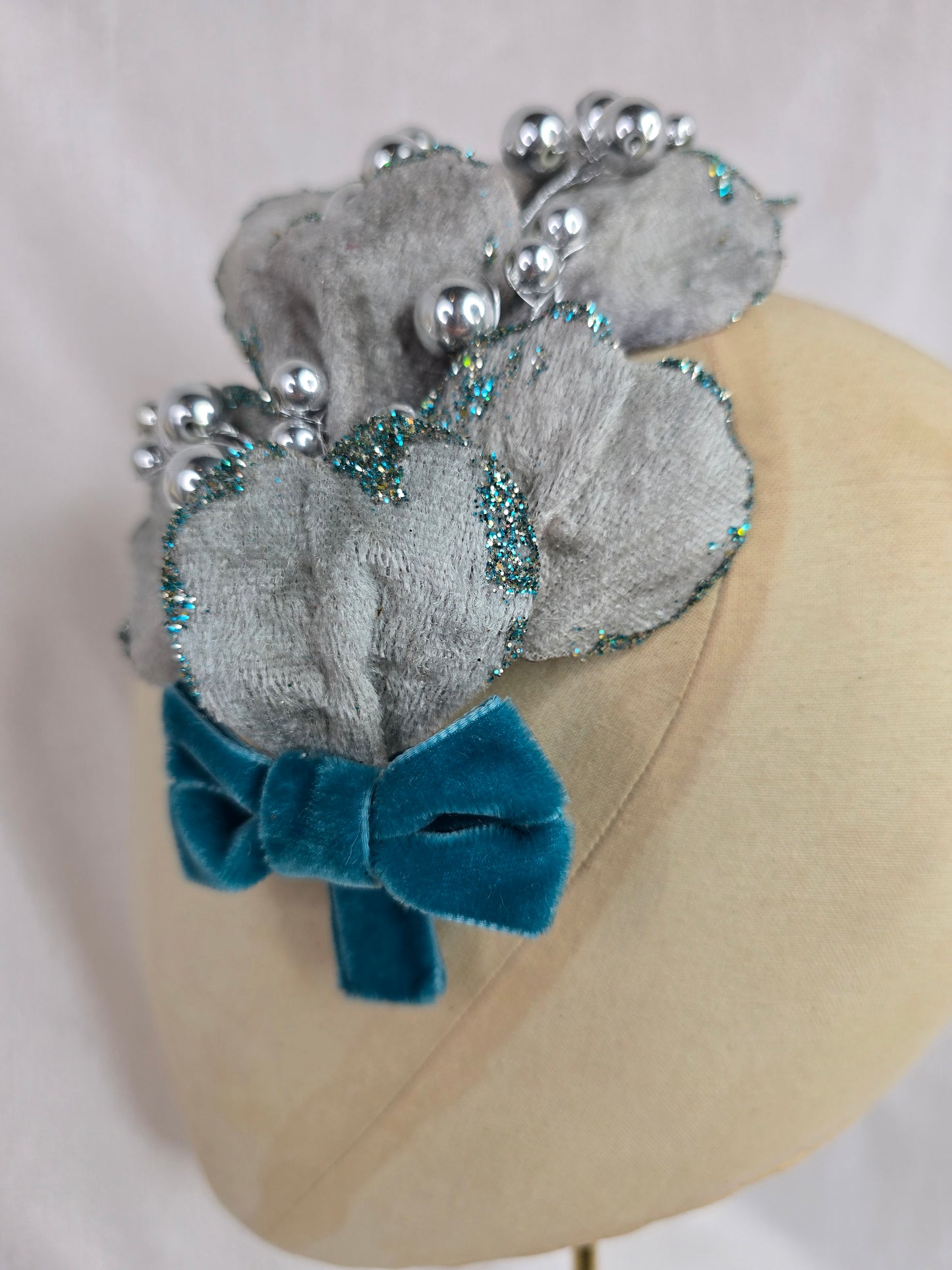 Silver velvet and aqua petal fascinator with bow and berries
