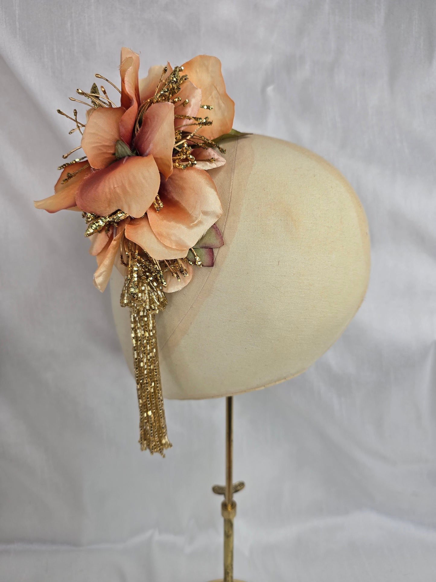 Medium pale orange and gold hair flower/corsage with beaded tassel