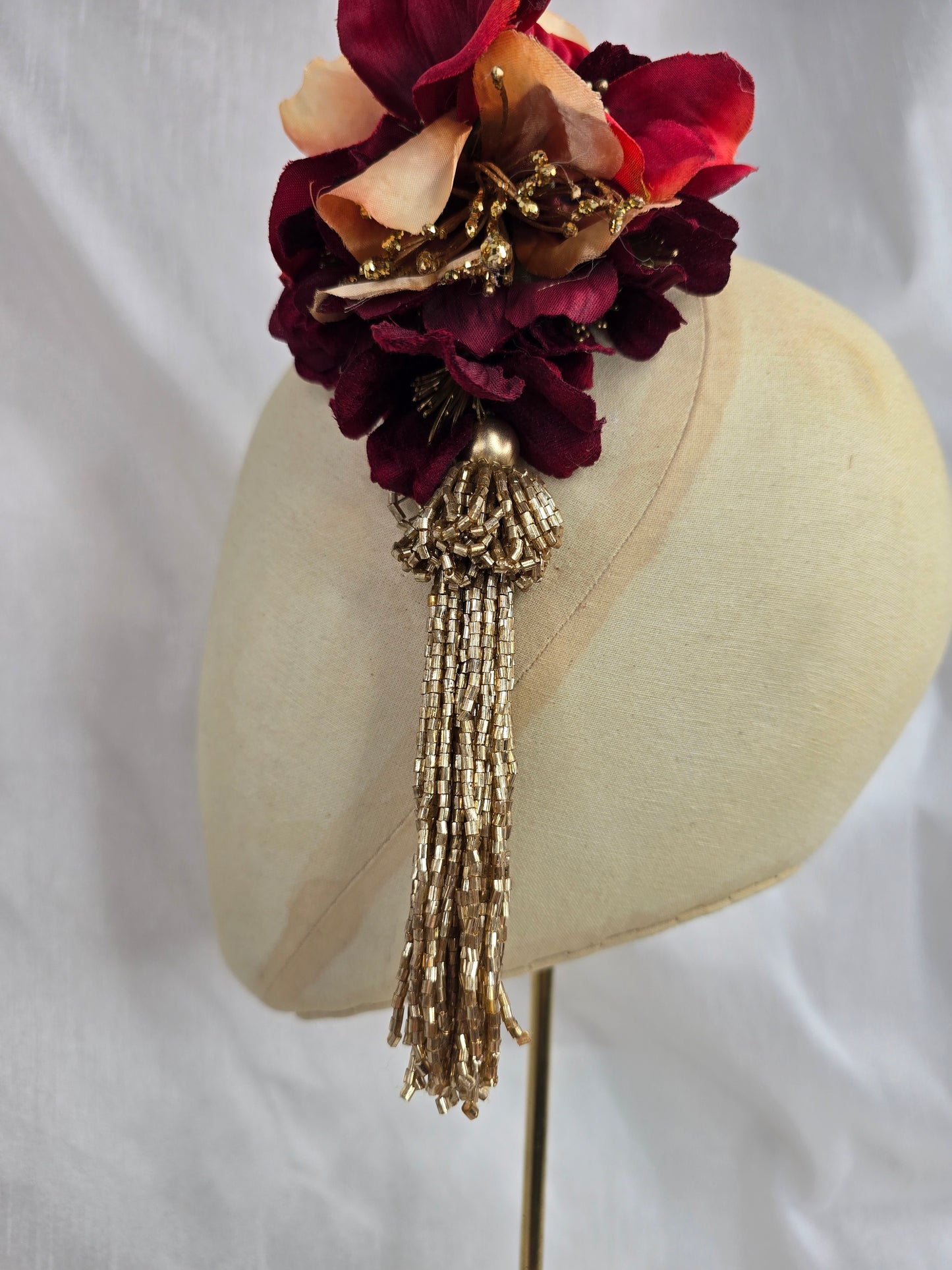 Medium pale orange, red and gold flower headpiece with gold beaded tassel