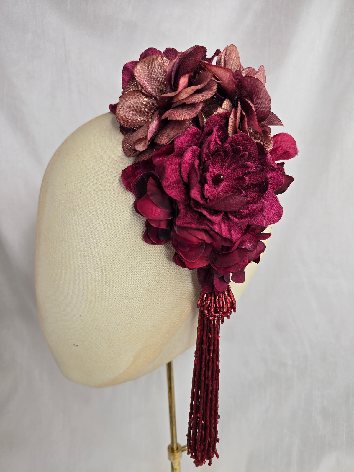 Medium burgundy and maroon flower headpiece/corsage with beaded tassel