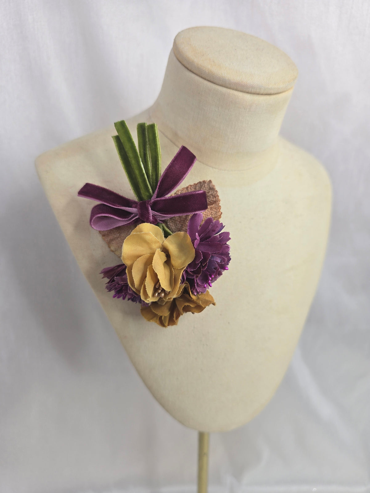 Mustard and purple blossom corsage