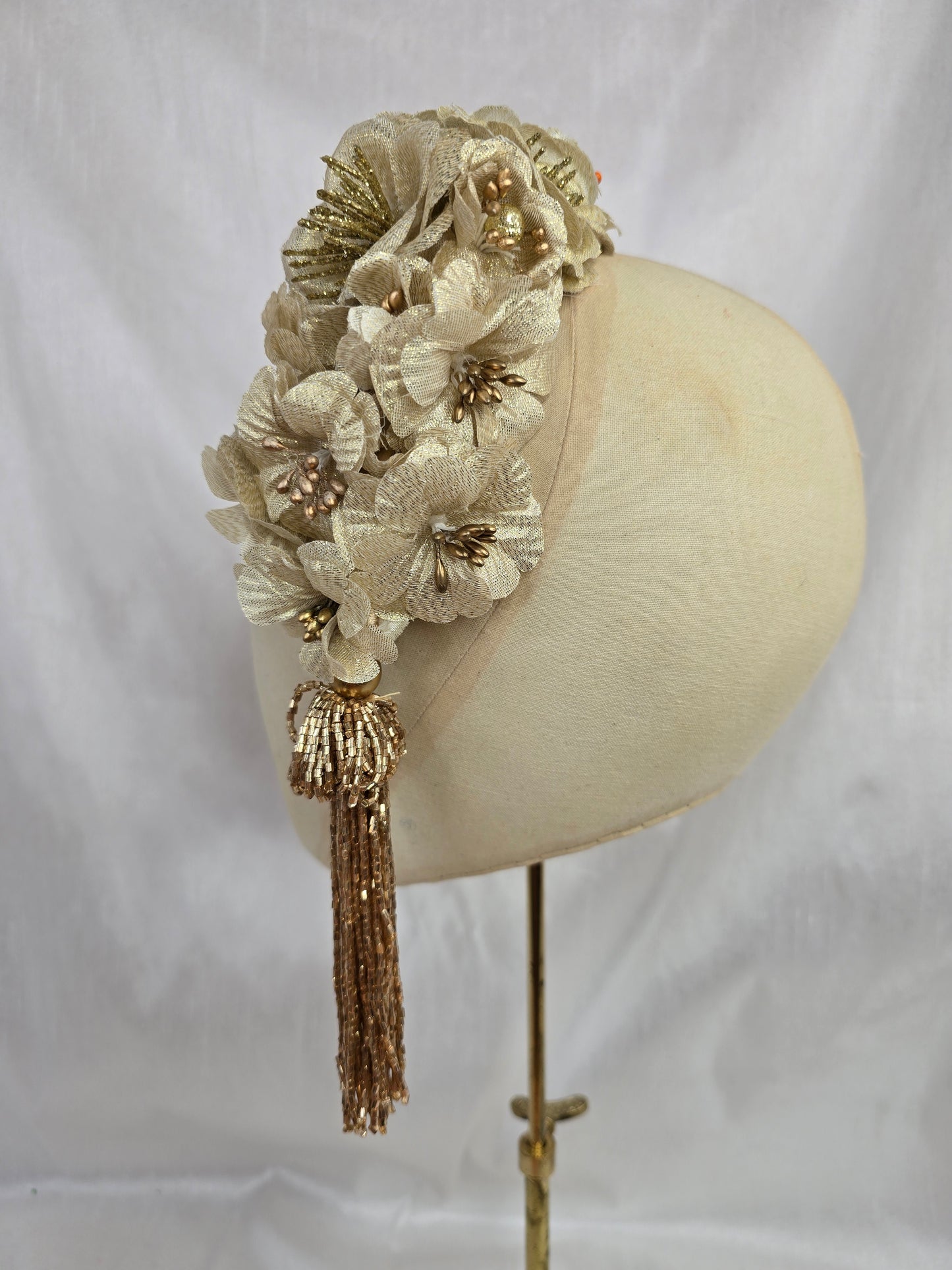 Large gold flower headpiece with beaded tassel