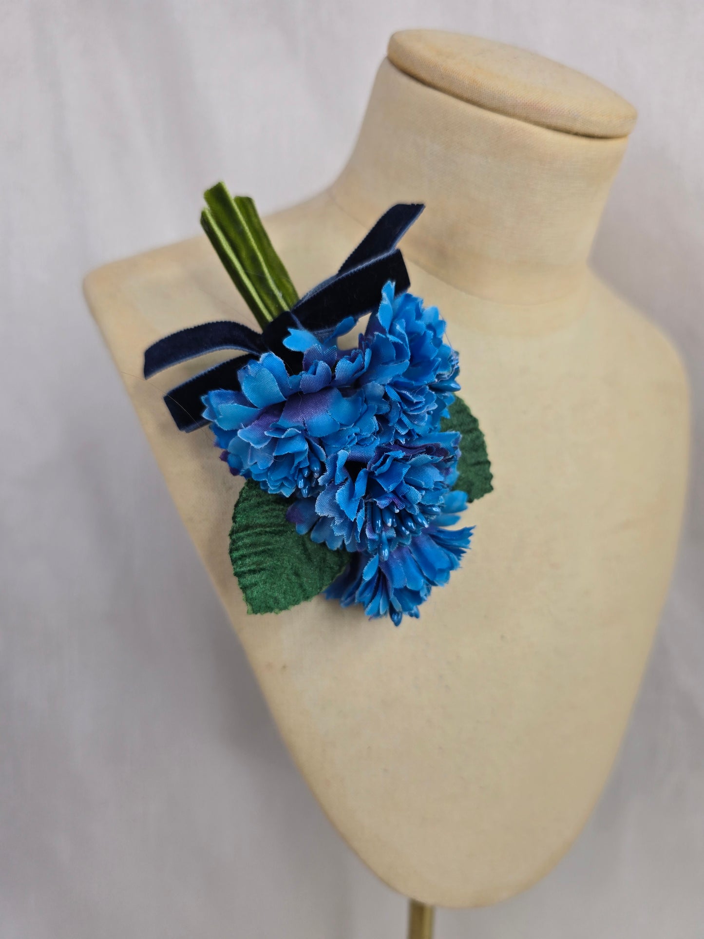 Small azure blue blossom corsage