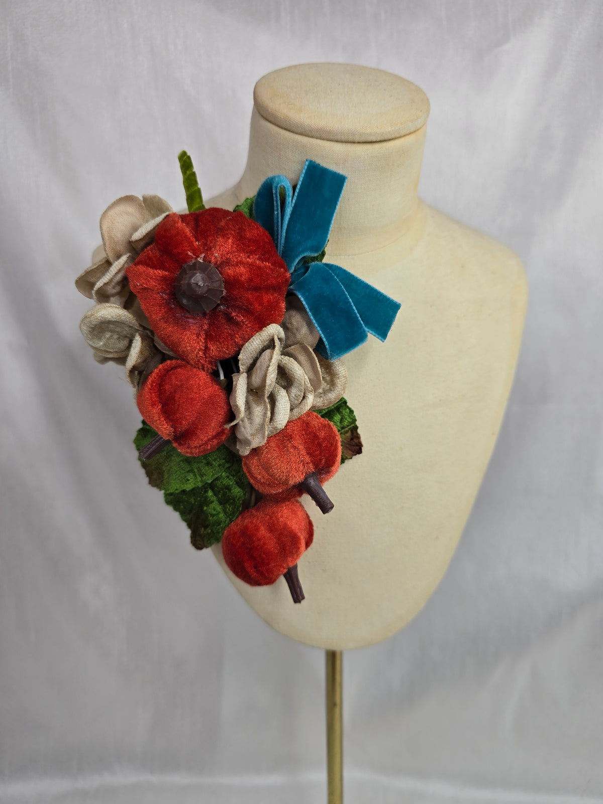 Velvet pumpkin corsage with teal bow
