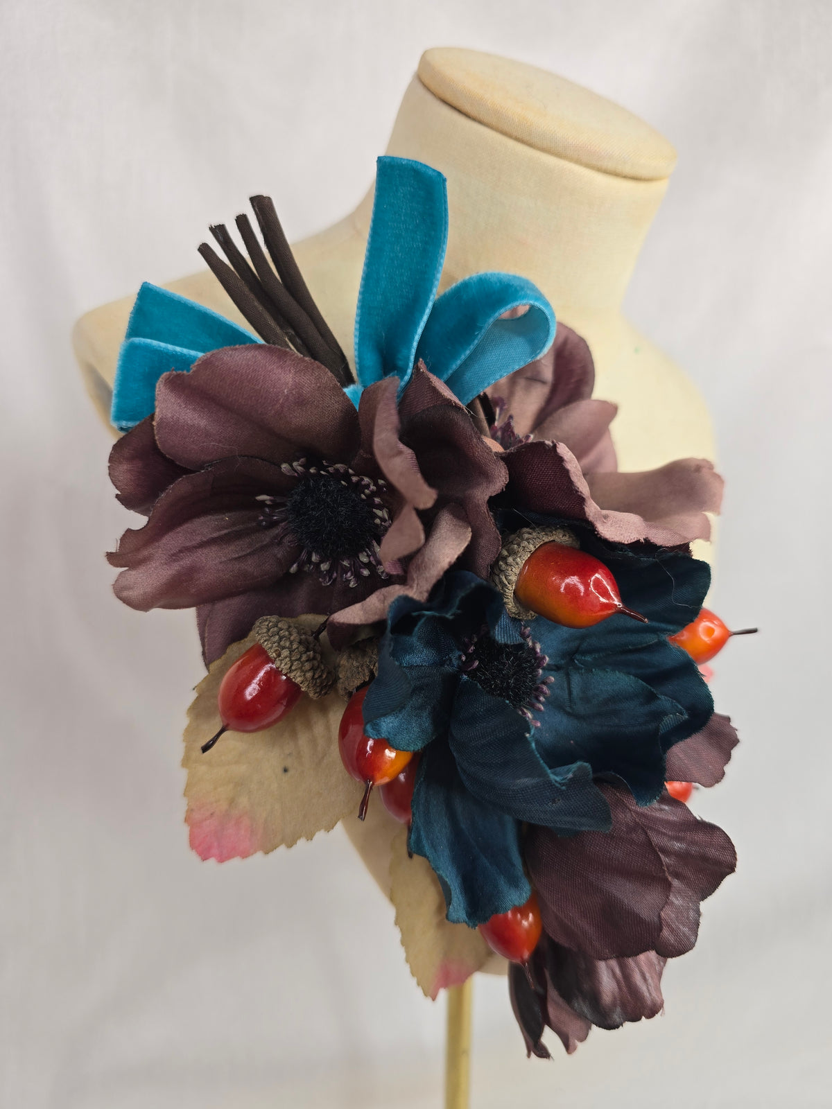 Brown and teal anemone and acorn corsage