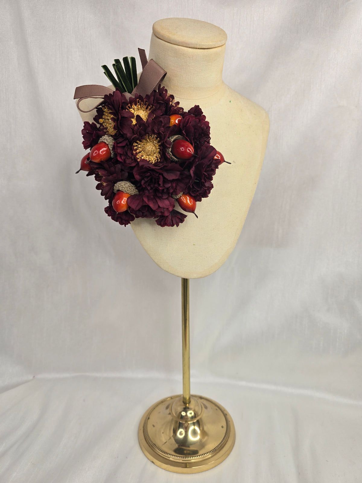 Maroon chrysanthemum and acorn corsage
