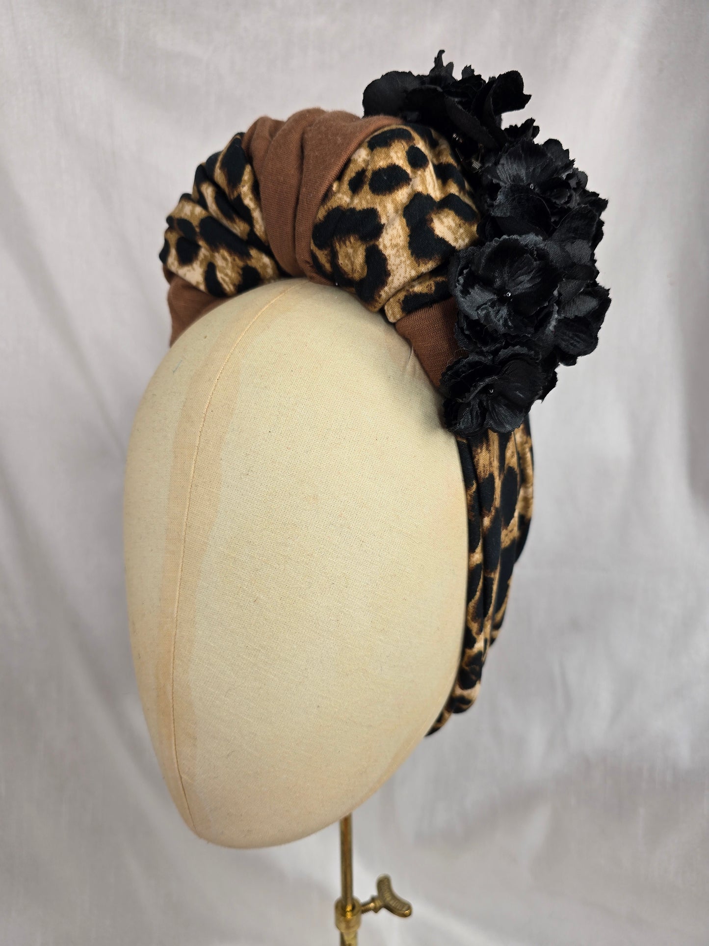 Leopard and tan stretch jersey turban with flower trim and corsage