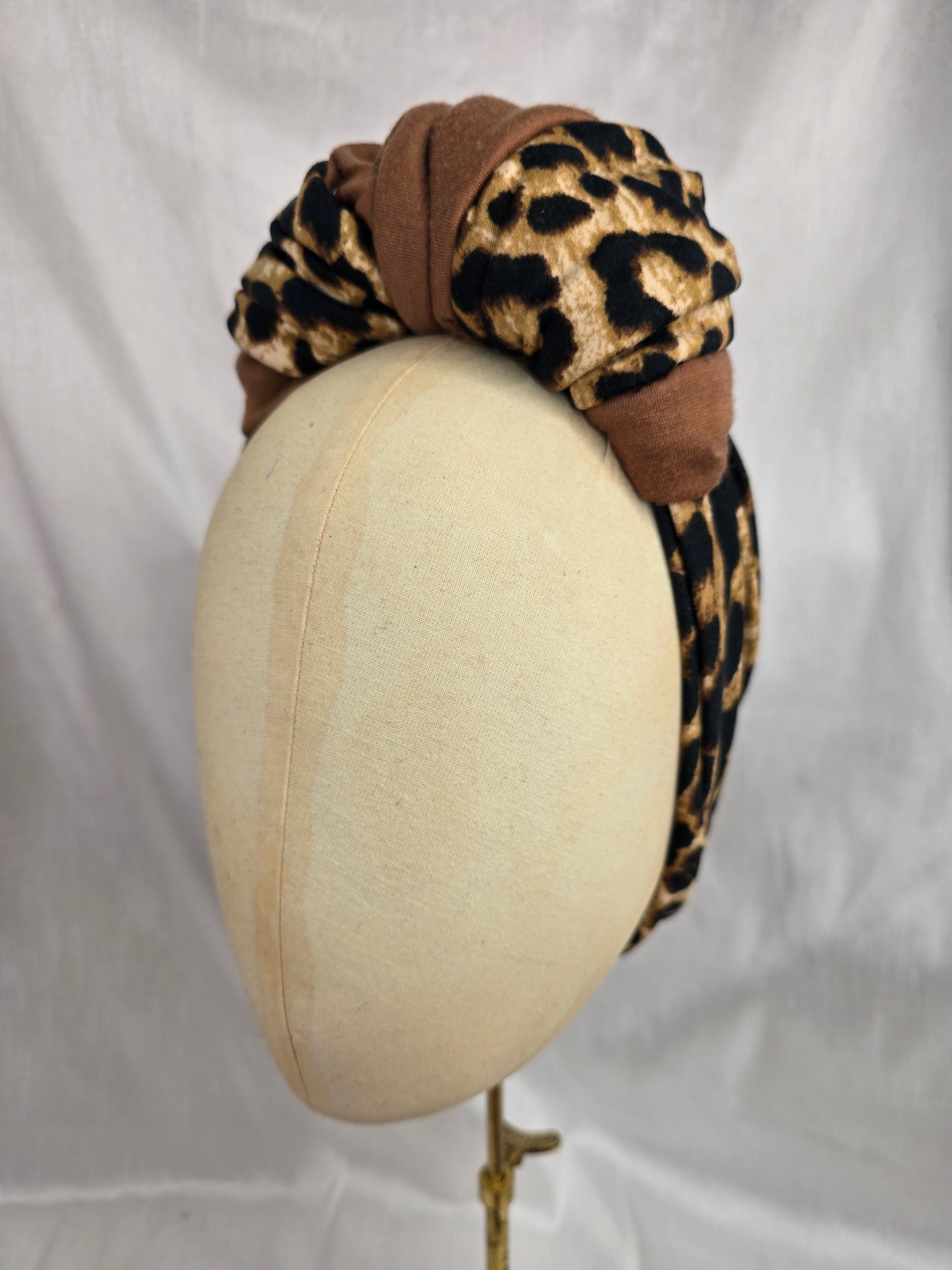 Leopard and tan stretch jersey turban with flower trim and corsage