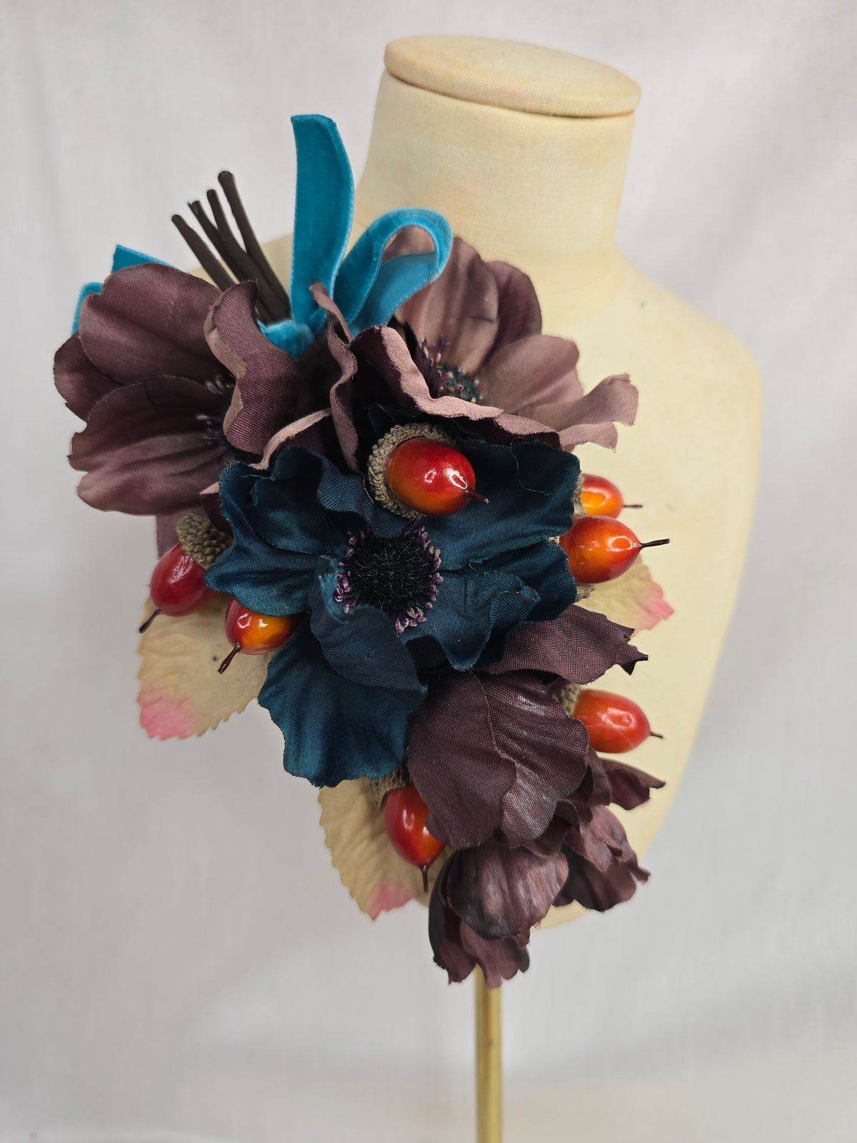 Brown and teal anemone and acorn corsage