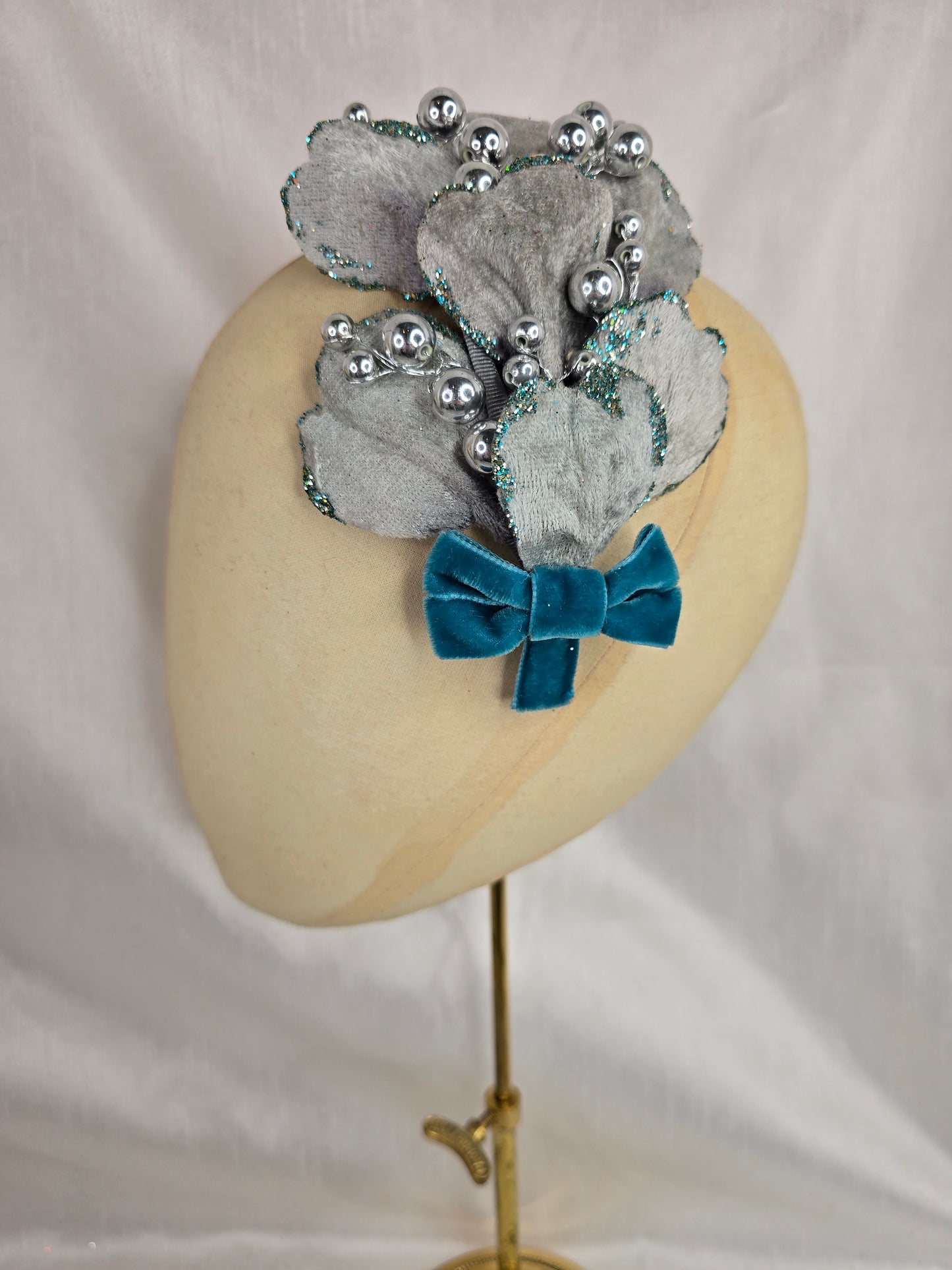 Silver velvet and aqua petal fascinator with bow and berries