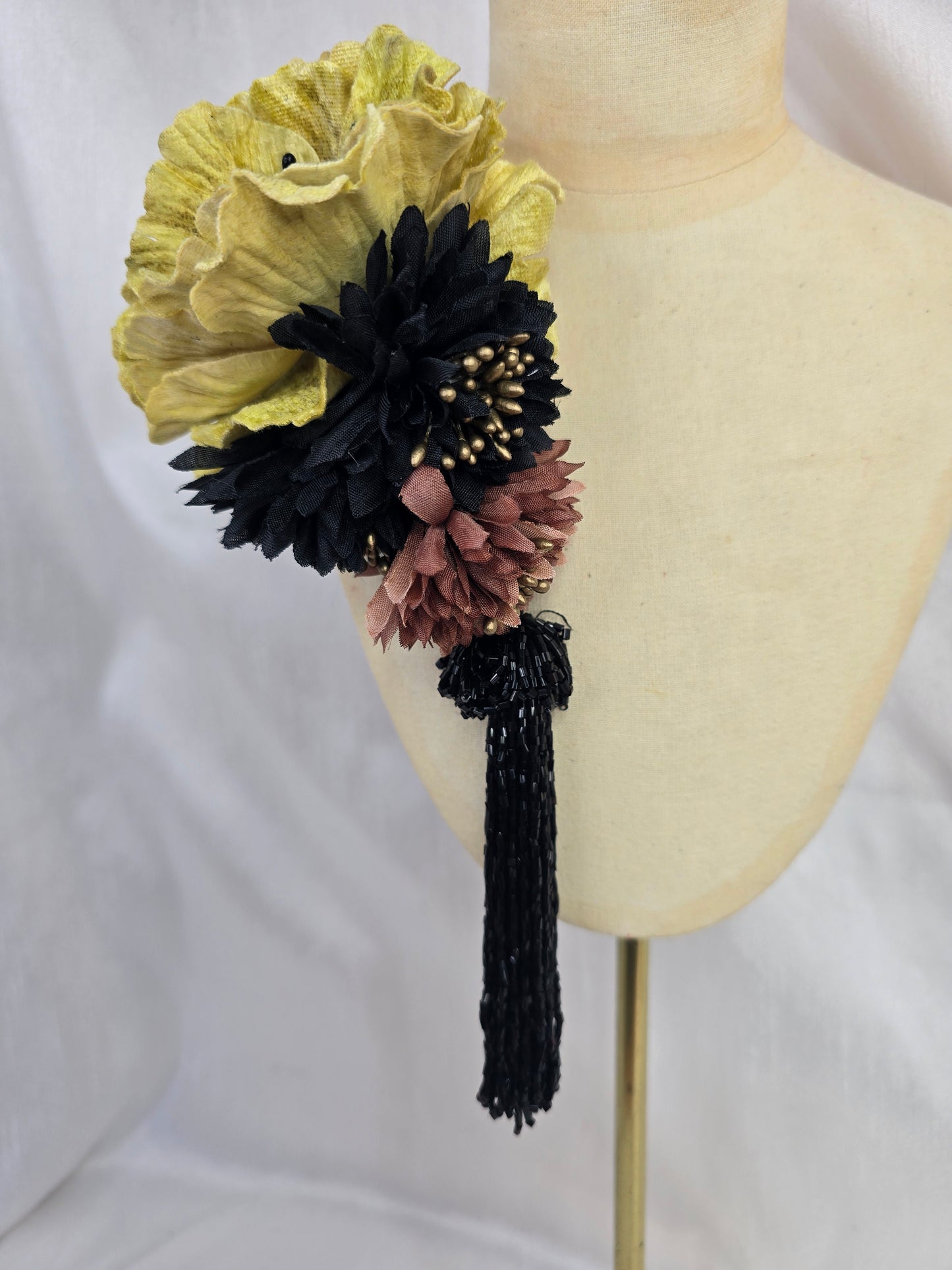Medium chartruese yellow, black and gold flower headpiece with black beaded tassel