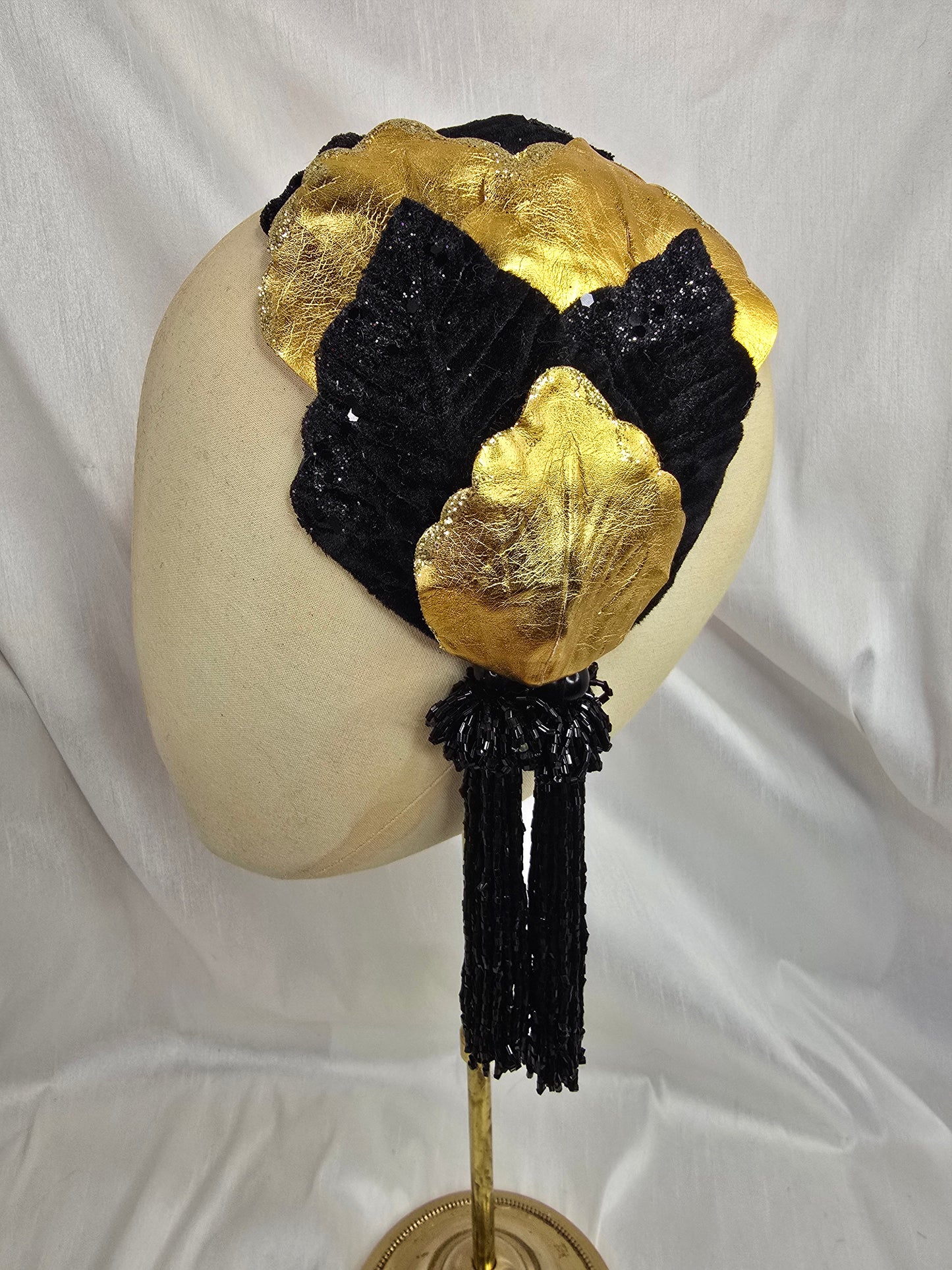 Black and gold glittered half hat/fascinator with beaded tassels