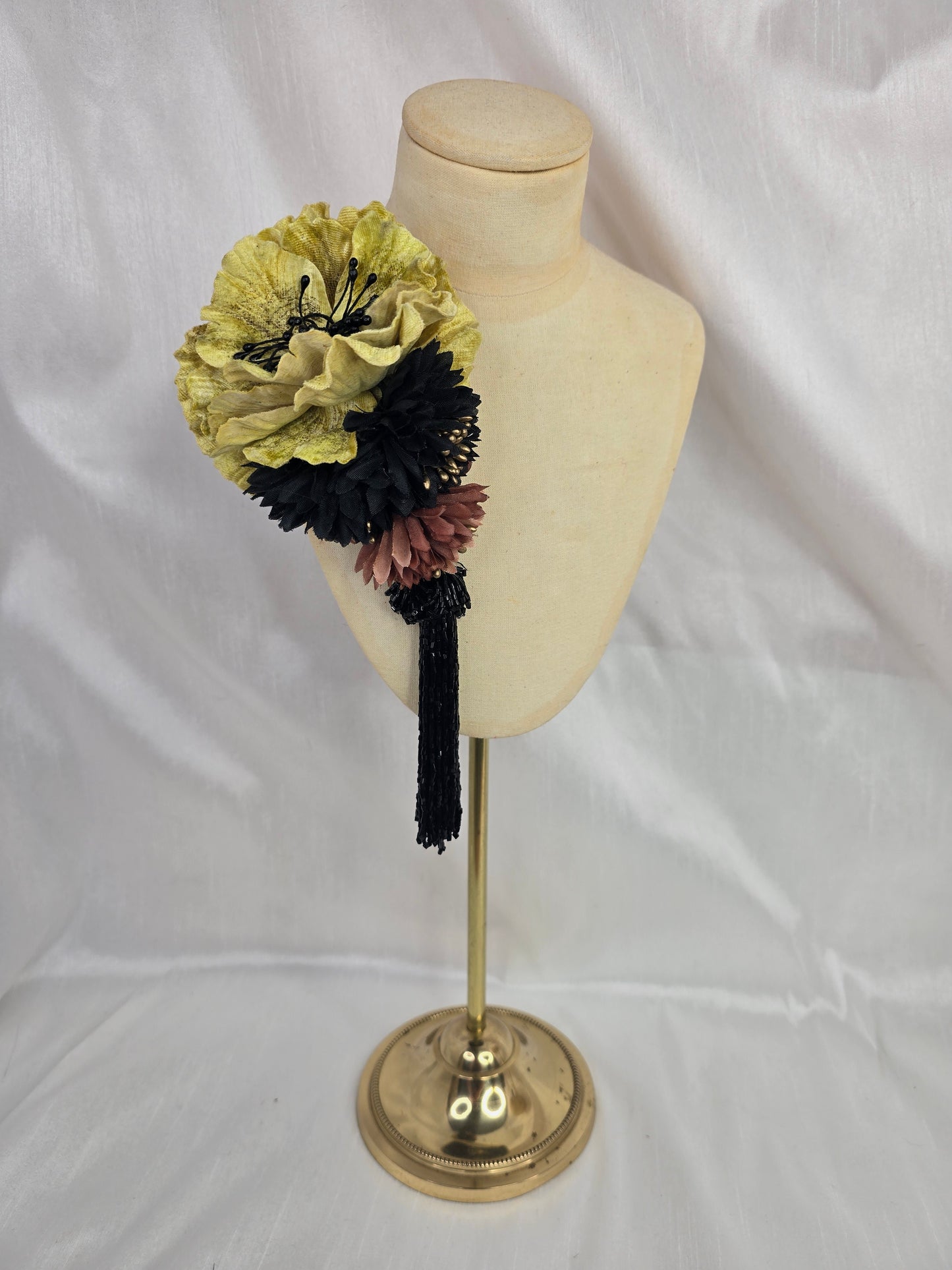 Medium chartruese yellow, black and gold flower headpiece with black beaded tassel