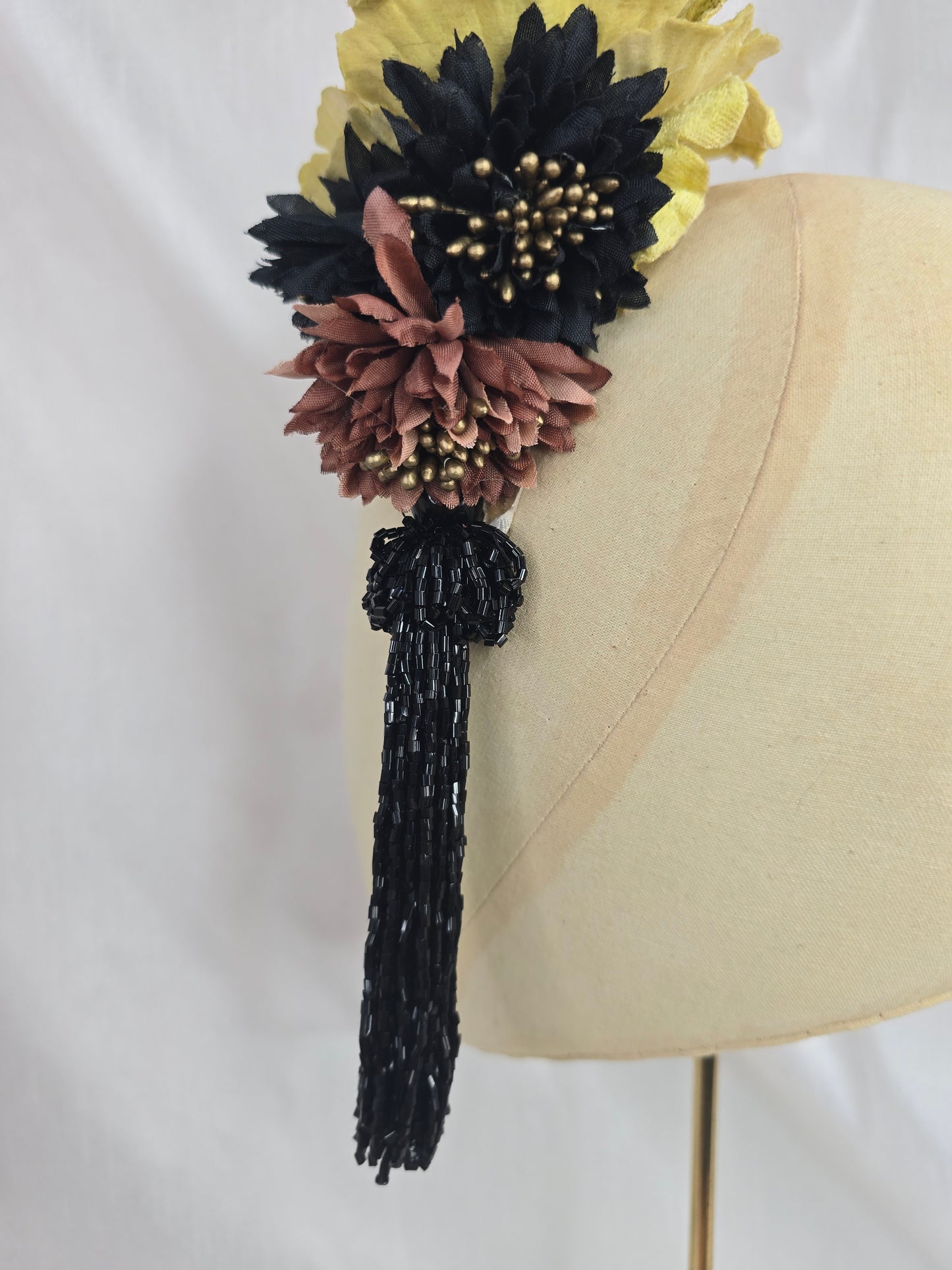 Medium chartruese yellow, black and gold flower headpiece with black beaded tassel