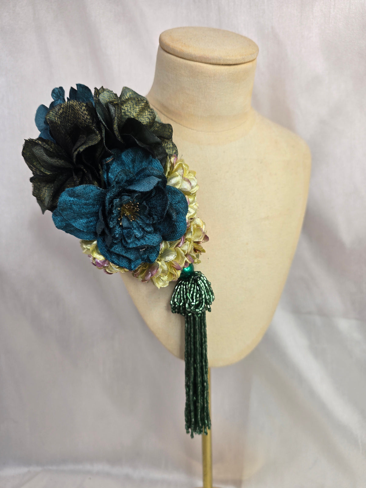 Medium teal, green, gold and chartreuse flower headpiece/corsage with beaded tassel