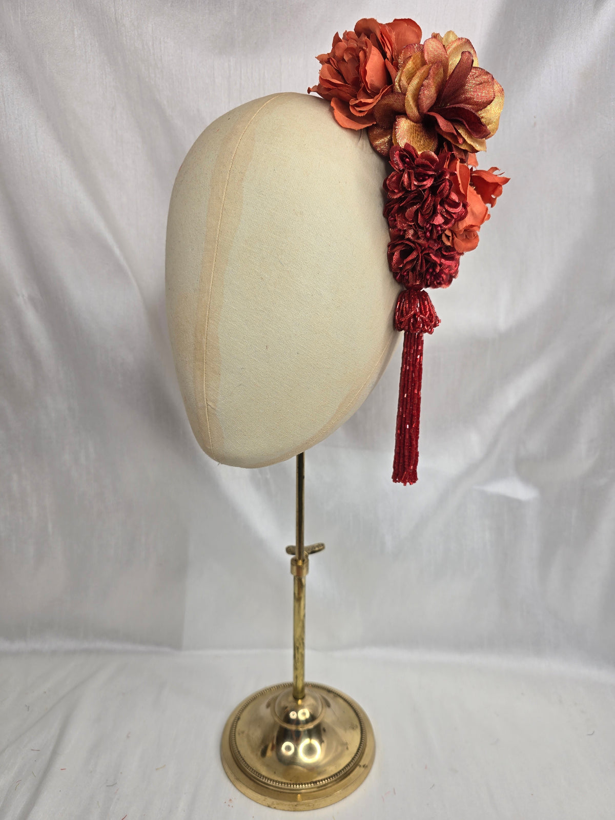 Medium autumn orange flower headpiece/corsage with beaded tassel