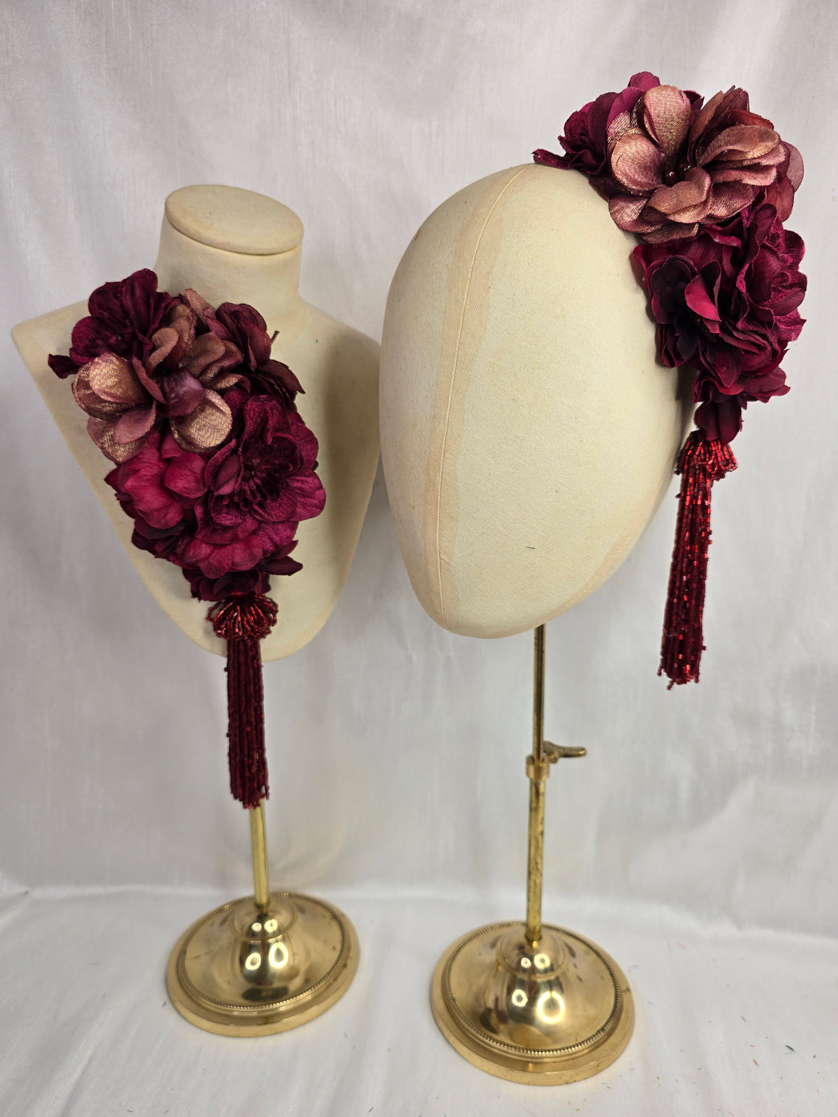 Medium burgundy and maroon flower headpiece/corsage with beaded tassel