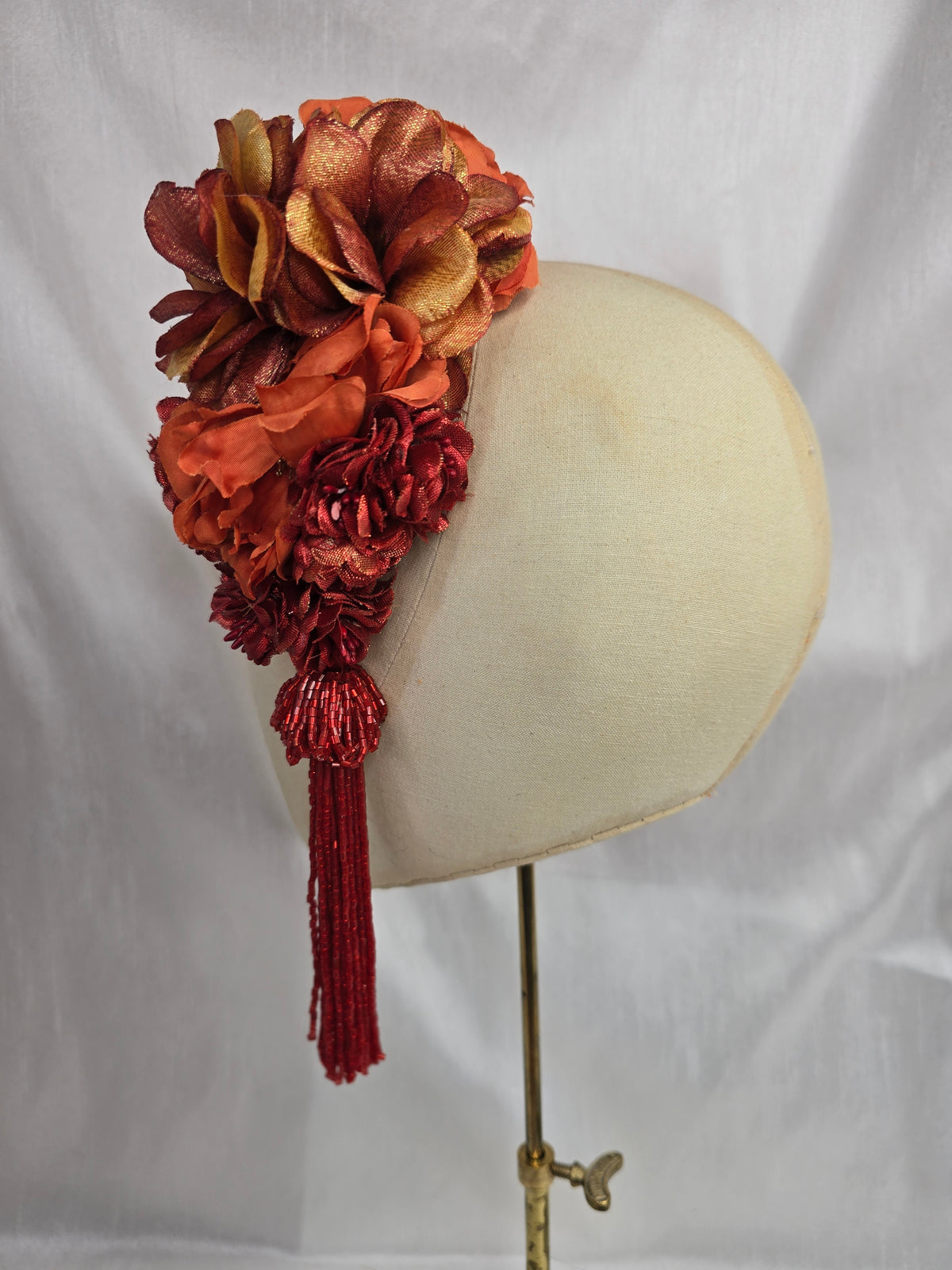 Medium autumn orange flower headpiece/corsage with beaded tassel