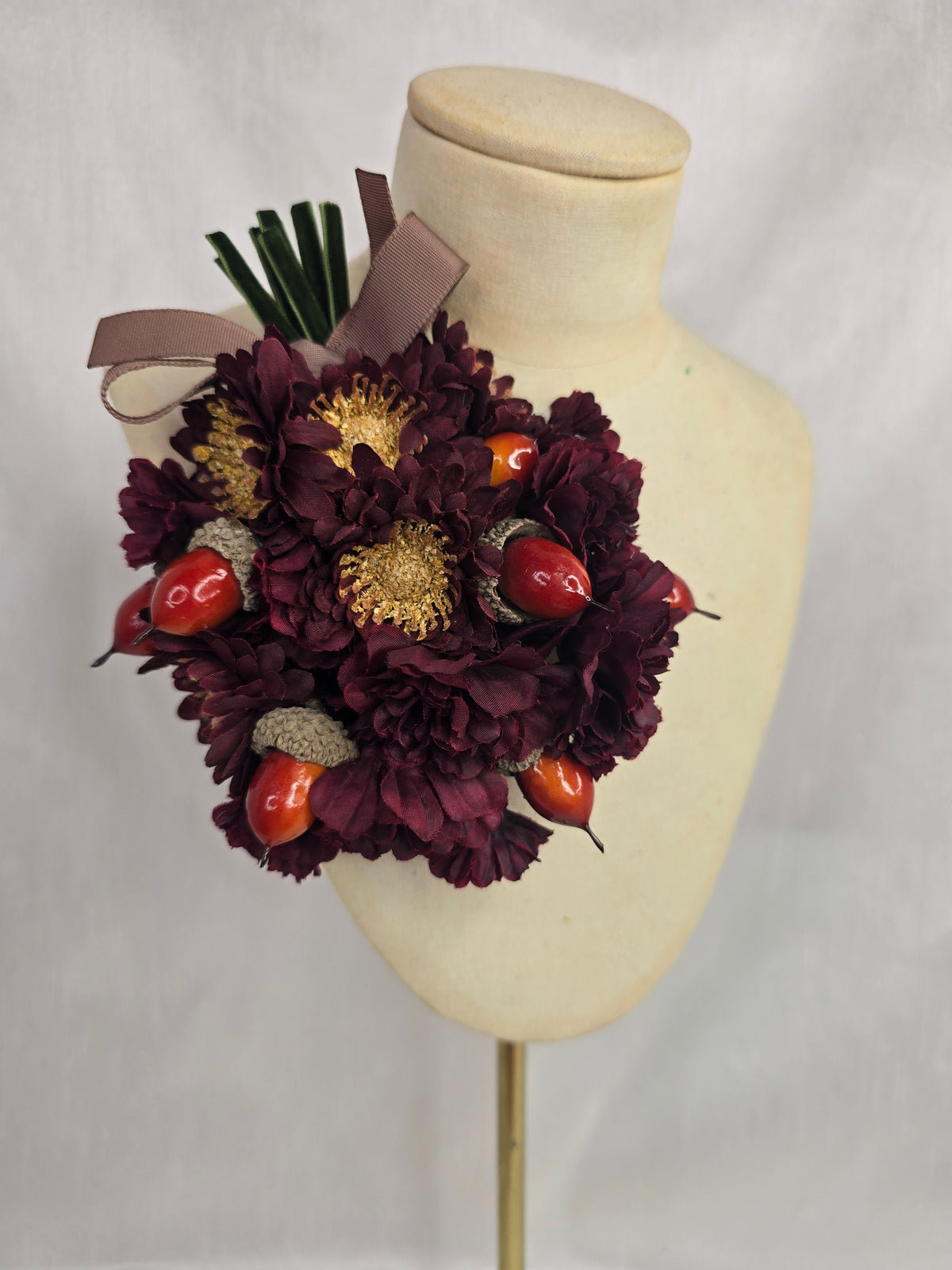 Maroon chrysanthemum and acorn corsage