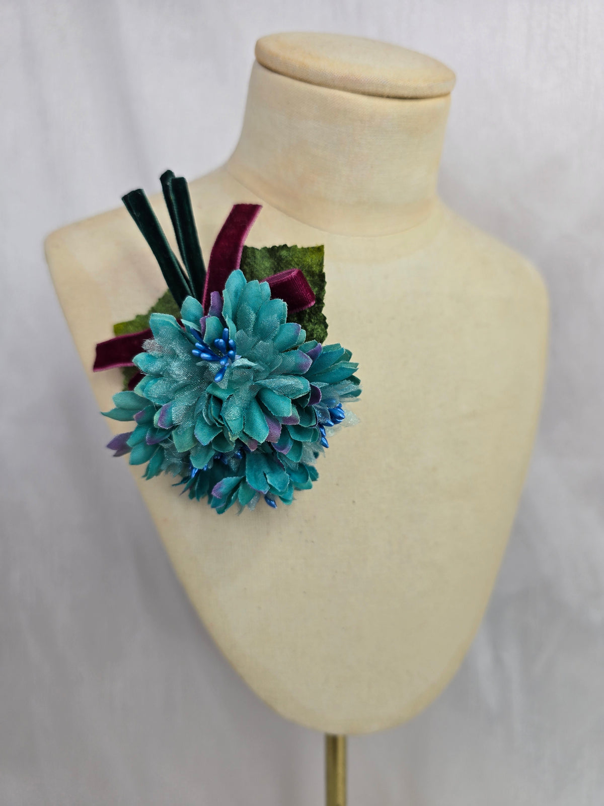 Small teal blossom corsage