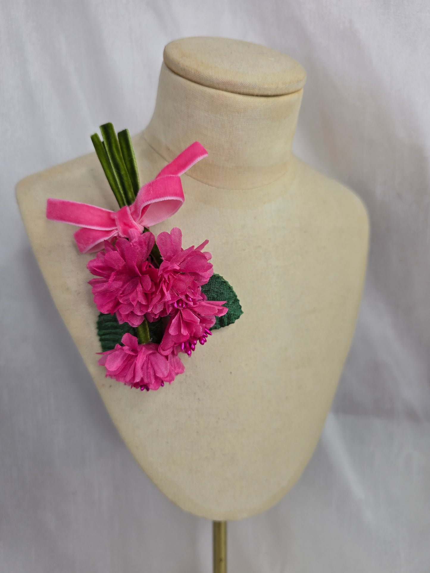 Small cerise pink blossom corsage