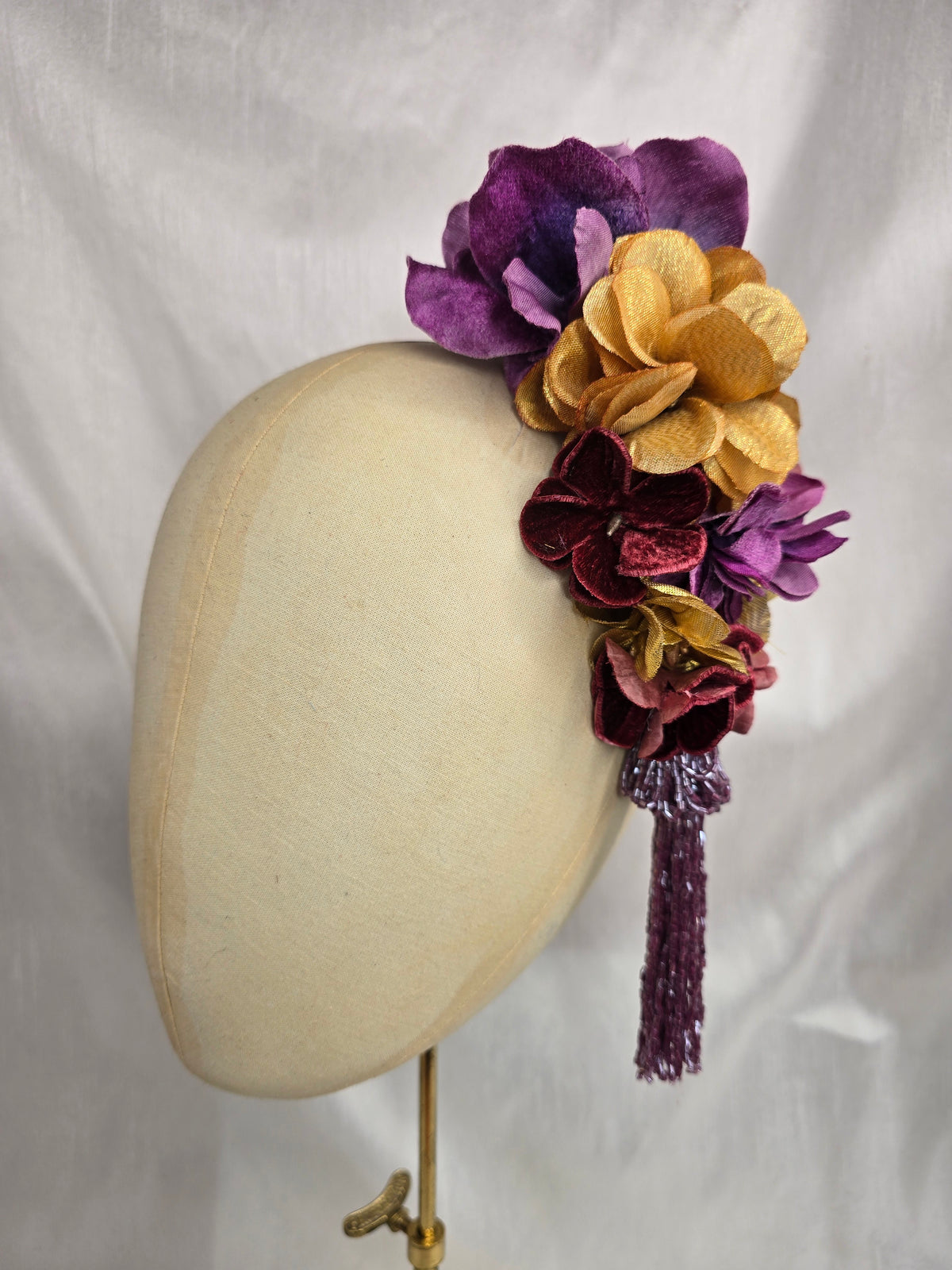 Medium purple and gold flower headpiece/corsage with beaded tassel